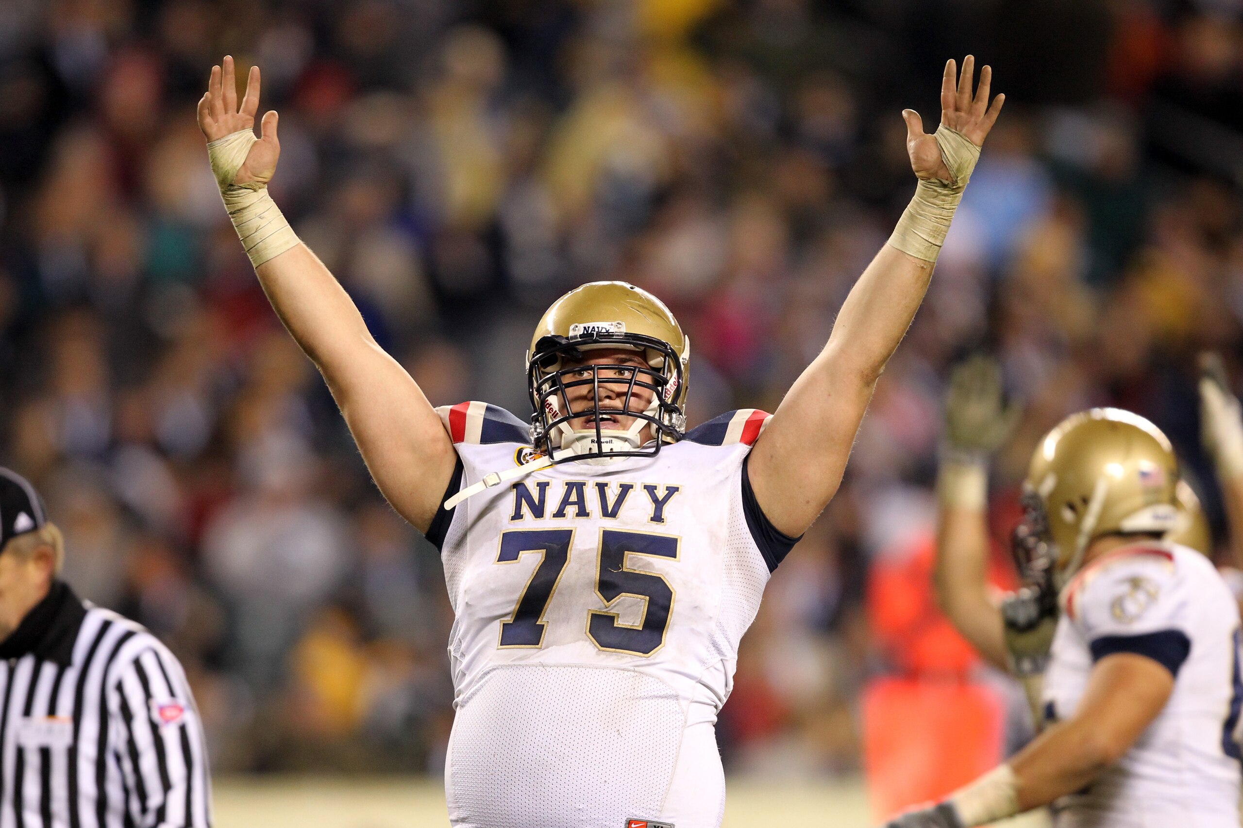 PHILADELPHIA - DECEMBER 11: Offensive lineman Brady DeMell #75 of the Navy Midshipmen celebrates a touchdown during a game against the Army Black Knights on December 11, 2010 at Lincoln Financial Field in Philadelphia, Pennsylvania. The Midshipmen won 31- PHILADELPHIA - DECEMBER 11: Offensive lineman Brady DeMell #75 of the Navy Midshipmen celebrates a touchdown during a game against the Army Black Knights on December 11, 2010 at Lincoln Financial Field in Philadelphia, Pennsylvania. The Midshipmen won 31-