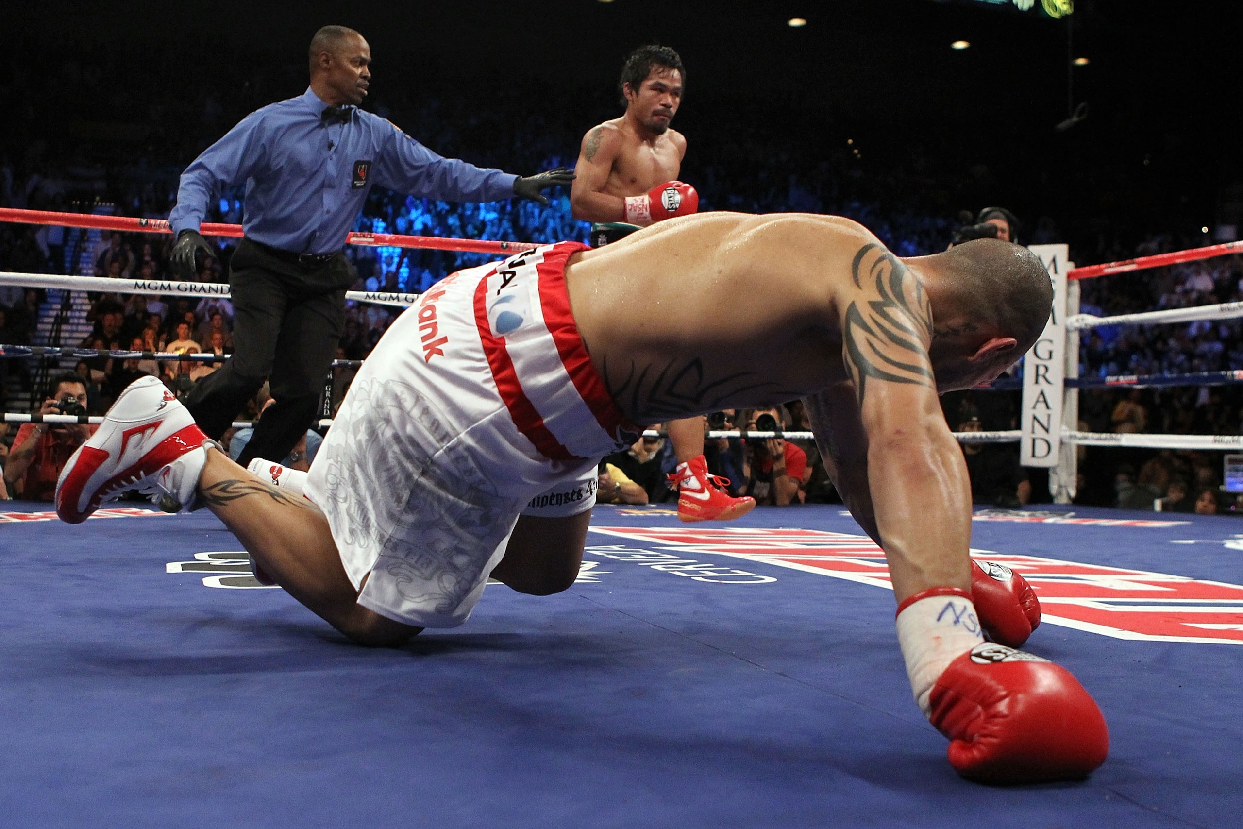 LAS VEGAS - NOVEMBER 14:  (L-R) Manny Pacquiao knocks down Miguel Cotto during their WBO welterweight title fight at the MGM Grand Garden Arena on November 14, 2009 in Las Vegas, Nevada.  (Photo by Al Bello/Getty Images)