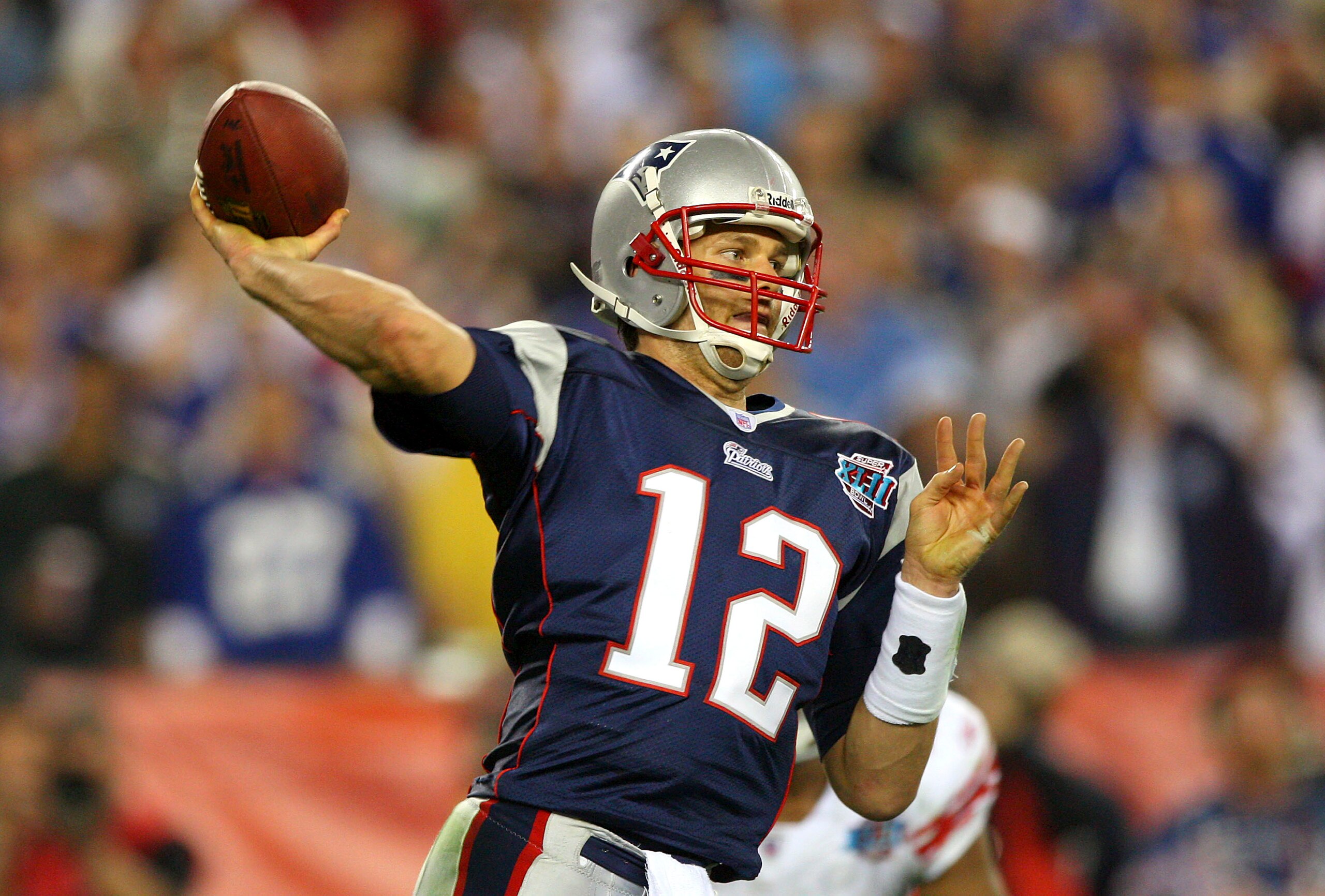 GLENDALE, AZ - FEBRUARY 03: Quarterback Tom Brady #12 of the New England Patriots drops back to pass against the New York Giants the second half of Super Bowl XLII on February 3, 2008 at the University of Phoenix Stadium in Glendale, Arizona. The Giants GLENDALE, AZ - FEBRUARY 03: Quarterback Tom Brady #12 of the New England Patriots drops back to pass against the New York Giants the second half of Super Bowl XLII on February 3, 2008 at the University of Phoenix Stadium in Glendale, Arizona. The Giants