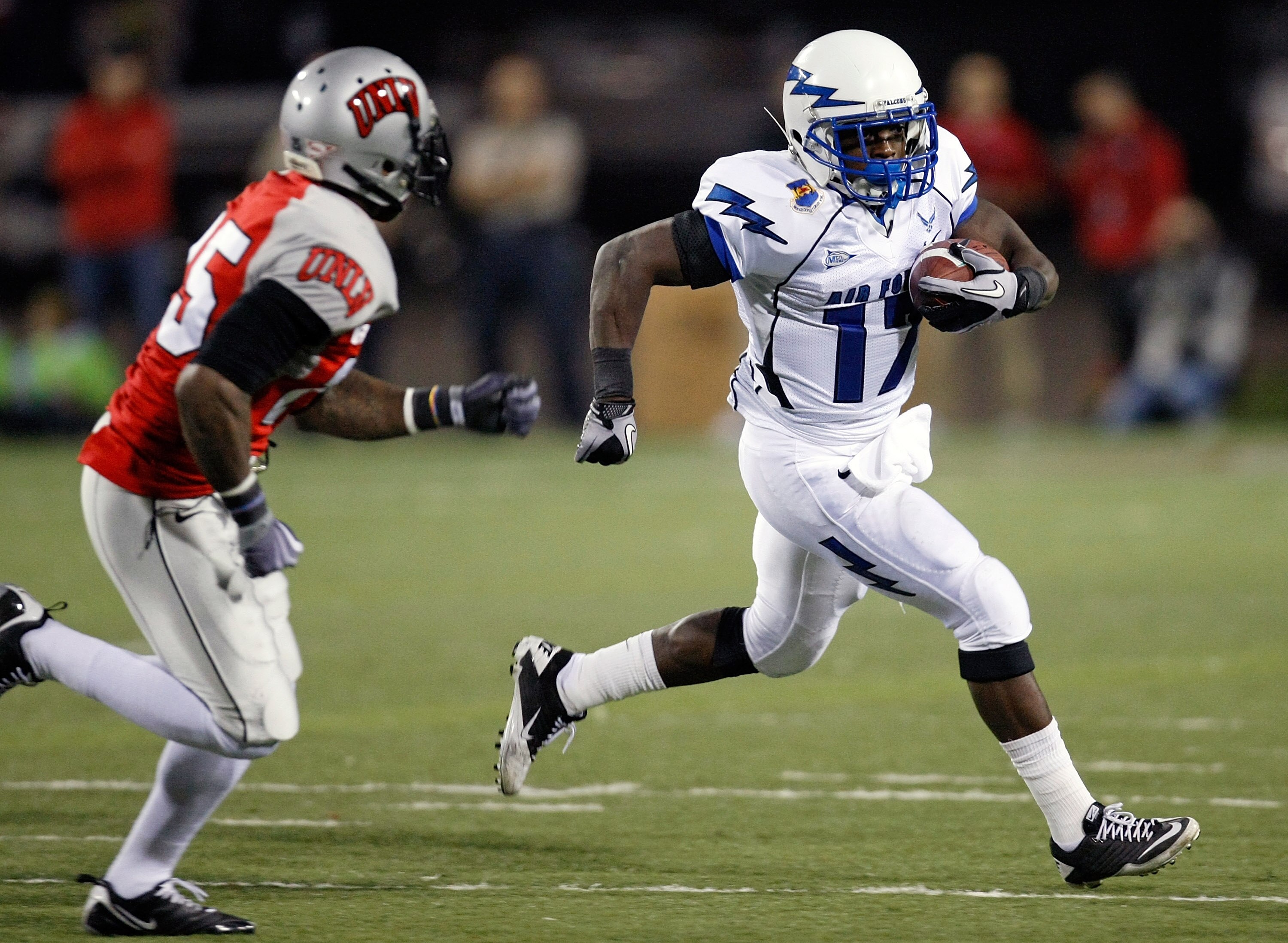 LAS VEGAS - NOVEMBER 18:  Asher Clark #17 of the Air Force Falcons runs for yardage against Mike Grant #17 of the UNLV Rebels during their game at Sam Boyd Stadium November 18, 2010 in Las Vegas, Nevada. Air Force won 35-20.  (Photo by Ethan Miller/Getty