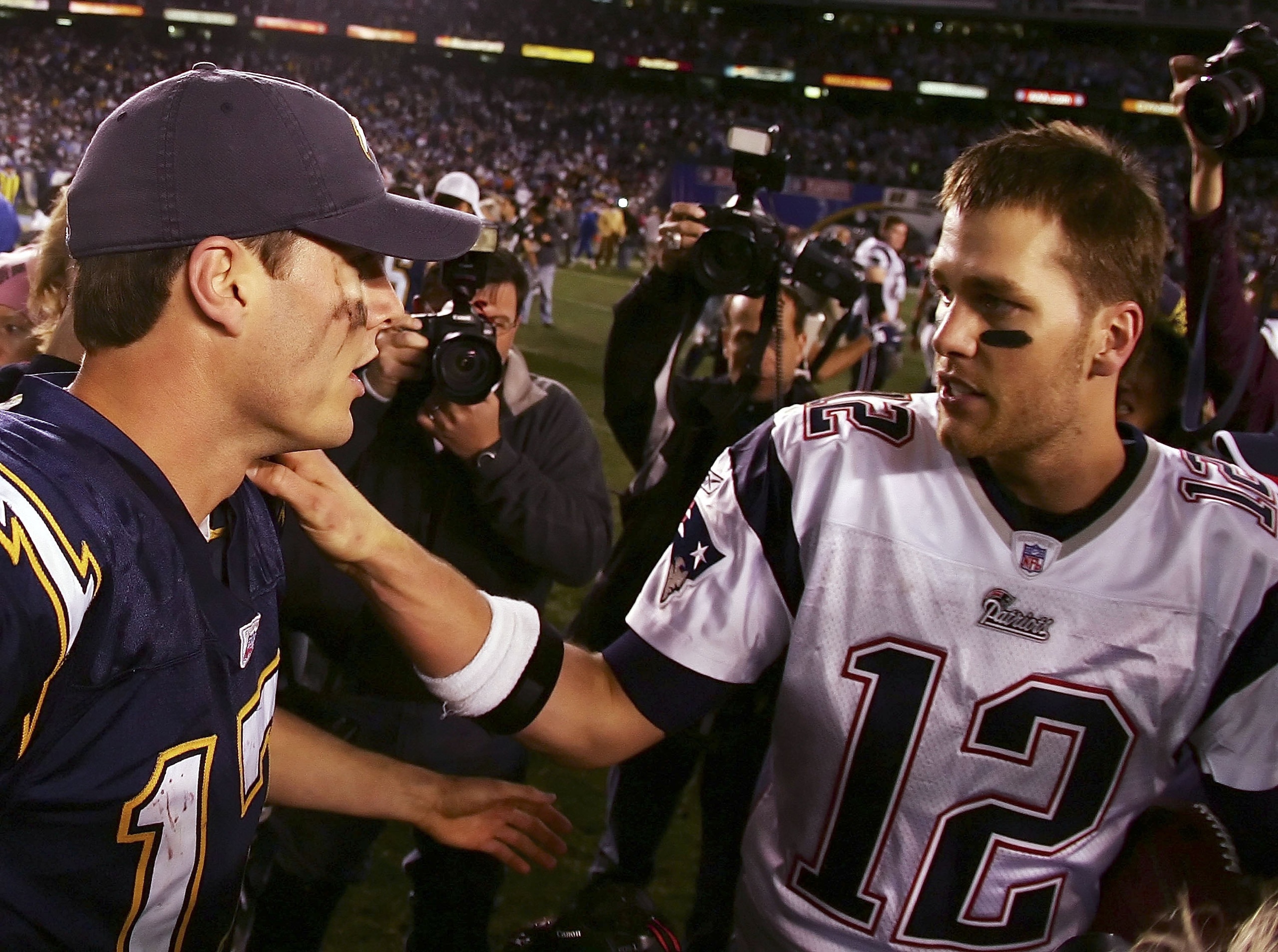 SAN DIEGO - JANUARY 14: (L-R) Quarterback Philip Rivers #17 of the San Diego Chargers and quarterback Tom Brady #12 of the New England Patriots meet after the AFC Divisional Playoff Game held on January 14, 2007 at Qualcomm Stadium in San Diego, Californi SAN DIEGO - JANUARY 14: (L-R) Quarterback Philip Rivers #17 of the San Diego Chargers and quarterback Tom Brady #12 of the New England Patriots meet after the AFC Divisional Playoff Game held on January 14, 2007 at Qualcomm Stadium in San Diego, Californi