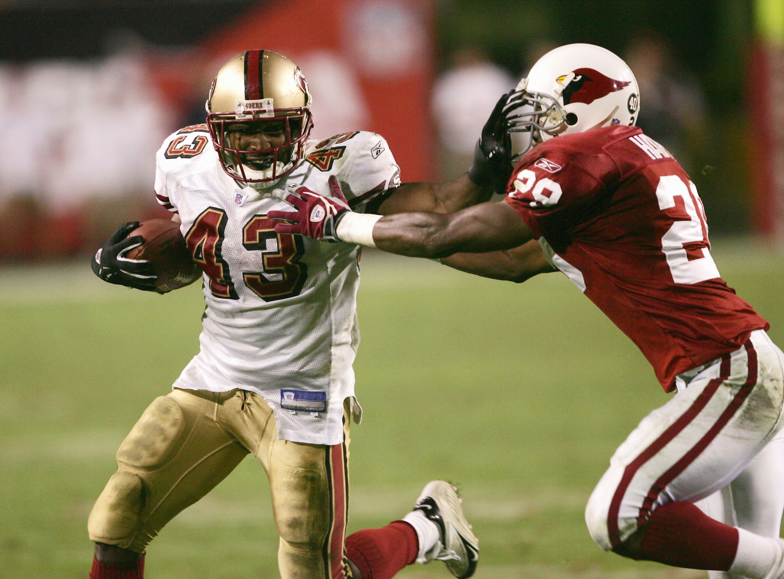 TEMPE, AZ - DECEMBER 12:  Running back Maurice Hicks #43 of the San Francisco 49ers breaks carries the ball to set up the winning field goal as defensive back Duane Starks #29 of the Arizona Cardinalsdefends  on December 12, 2004 at Sun Devil Stadium in T