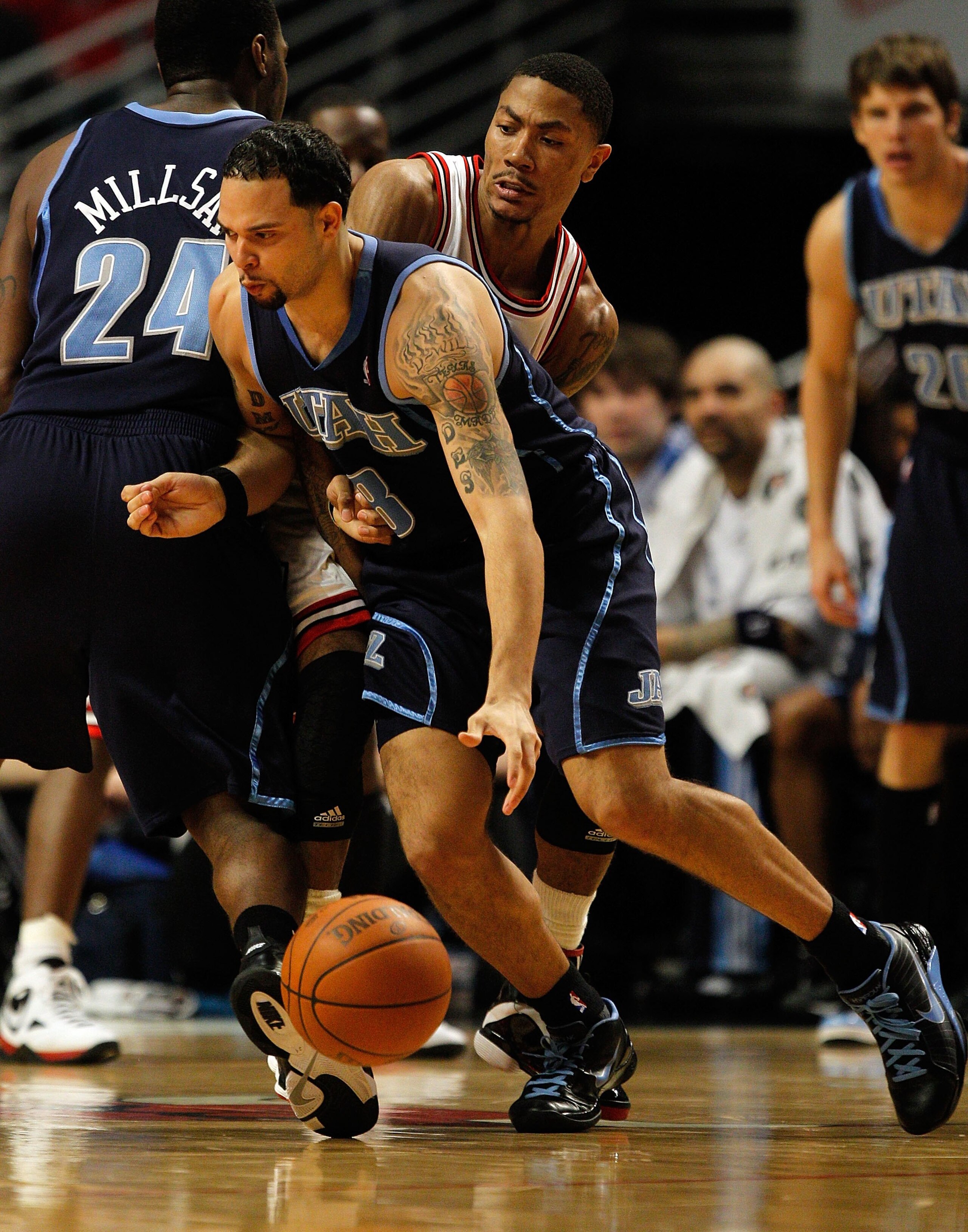 CHICAGO - MARCH 09: Deron Williams #8 of the Utah Jazz moves against Derrick Rose #1 of the Chicago Bulls as teammate Paul Millsap #24 sets a screen at the United Center on March 9, 2010 in Chicago, Illinois. The Jazz defeated the Bulls 132-108. NOTE TO U