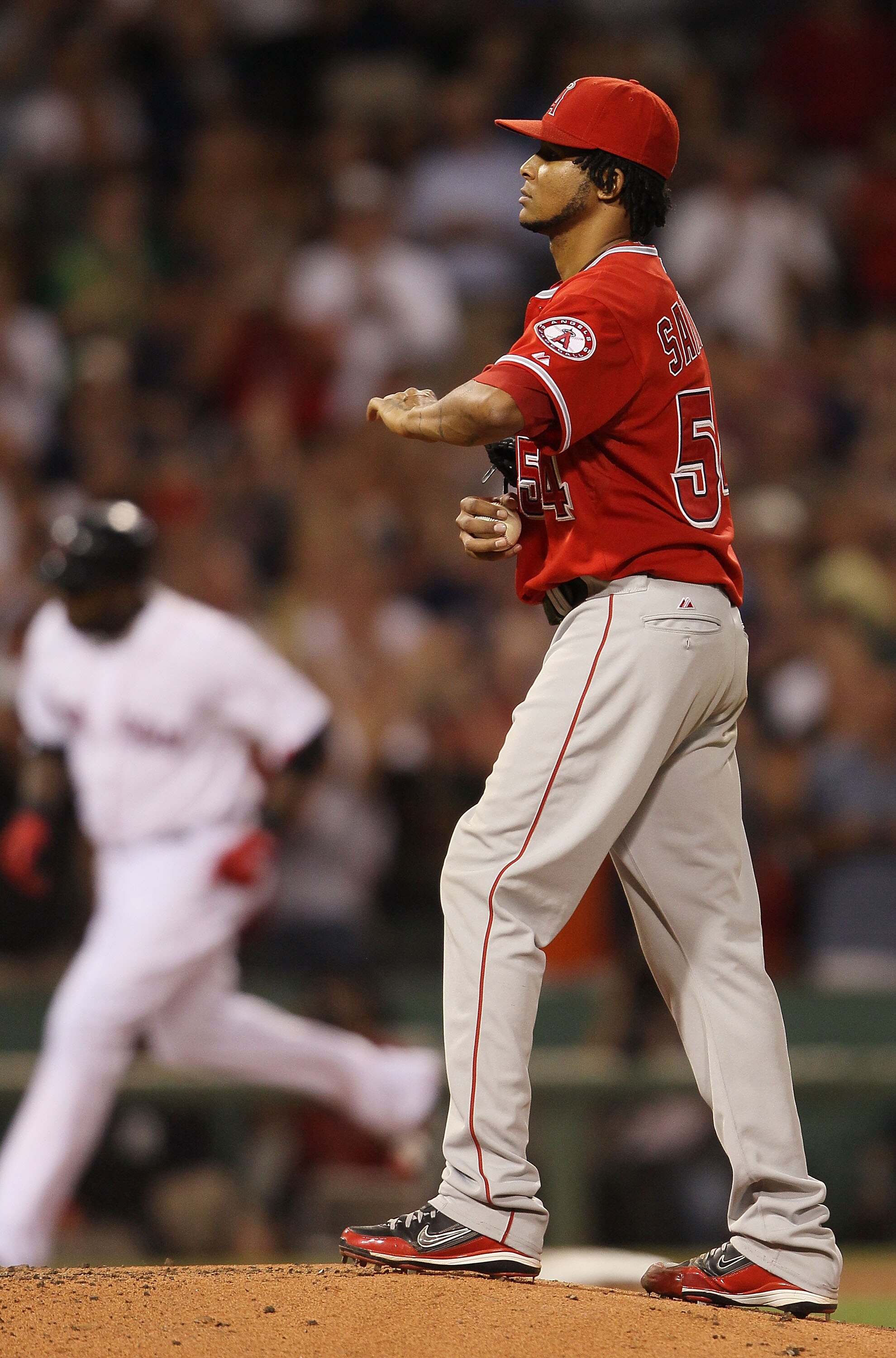 BOSTON - AUGUST 19:  Ervin Santana #54 of the Los Angeles Angels of Anaheim reacts as David Ortiz #34 of the Boston Red Sox rounds the bases after his solo home run in the fourth inning on August 19, 2010 at Fenway Park in Boston, Massachusetts.  (Photo b