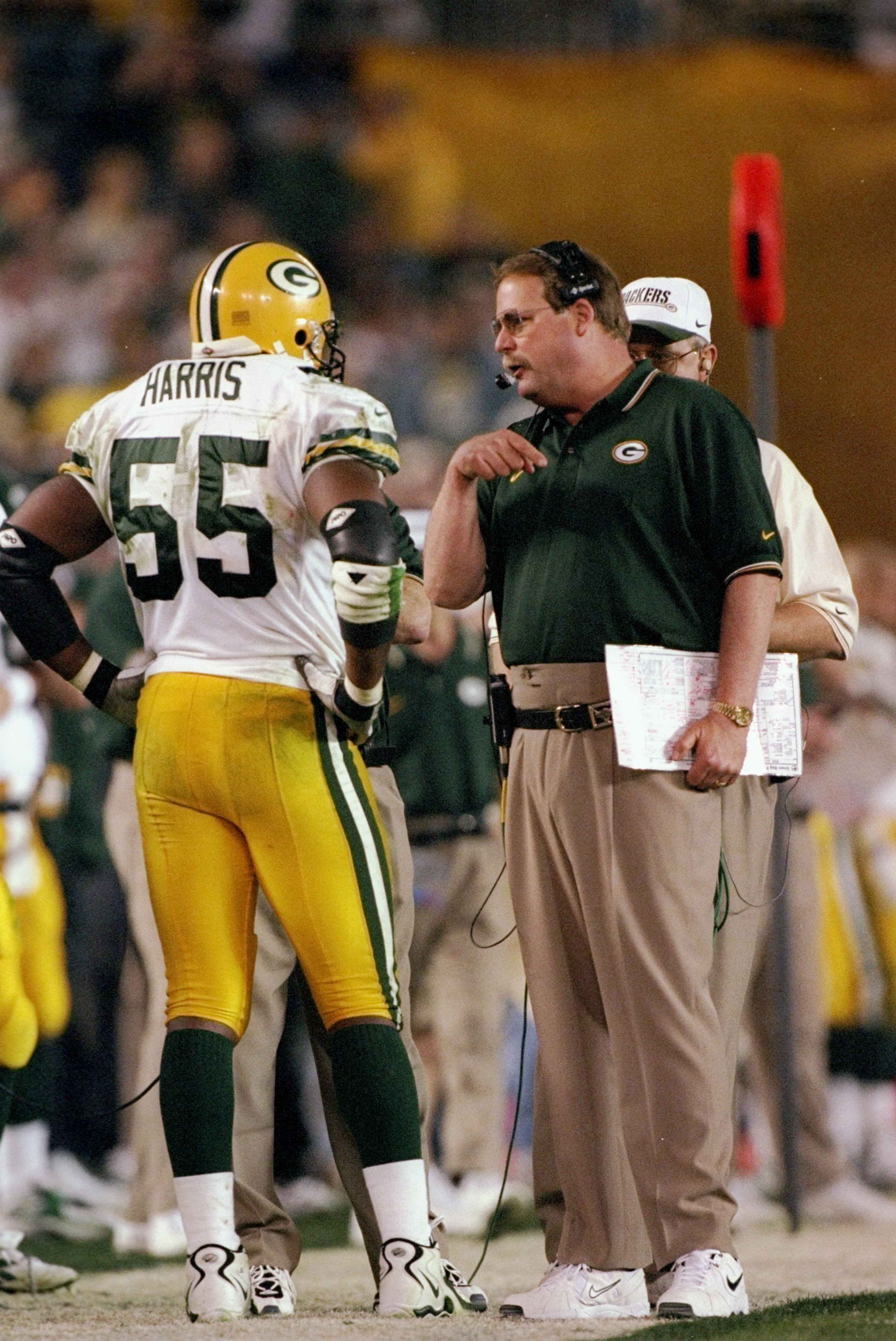 25 Jan 1998: Coach Mike Holmgren of the Green Bay Packers talks to Bernardo Harris #55 during Super Bowl XXXII at Qualcomm Stadium in San Diego, California. The Denver Broncos defeated the Green Bay Packers 31-24.