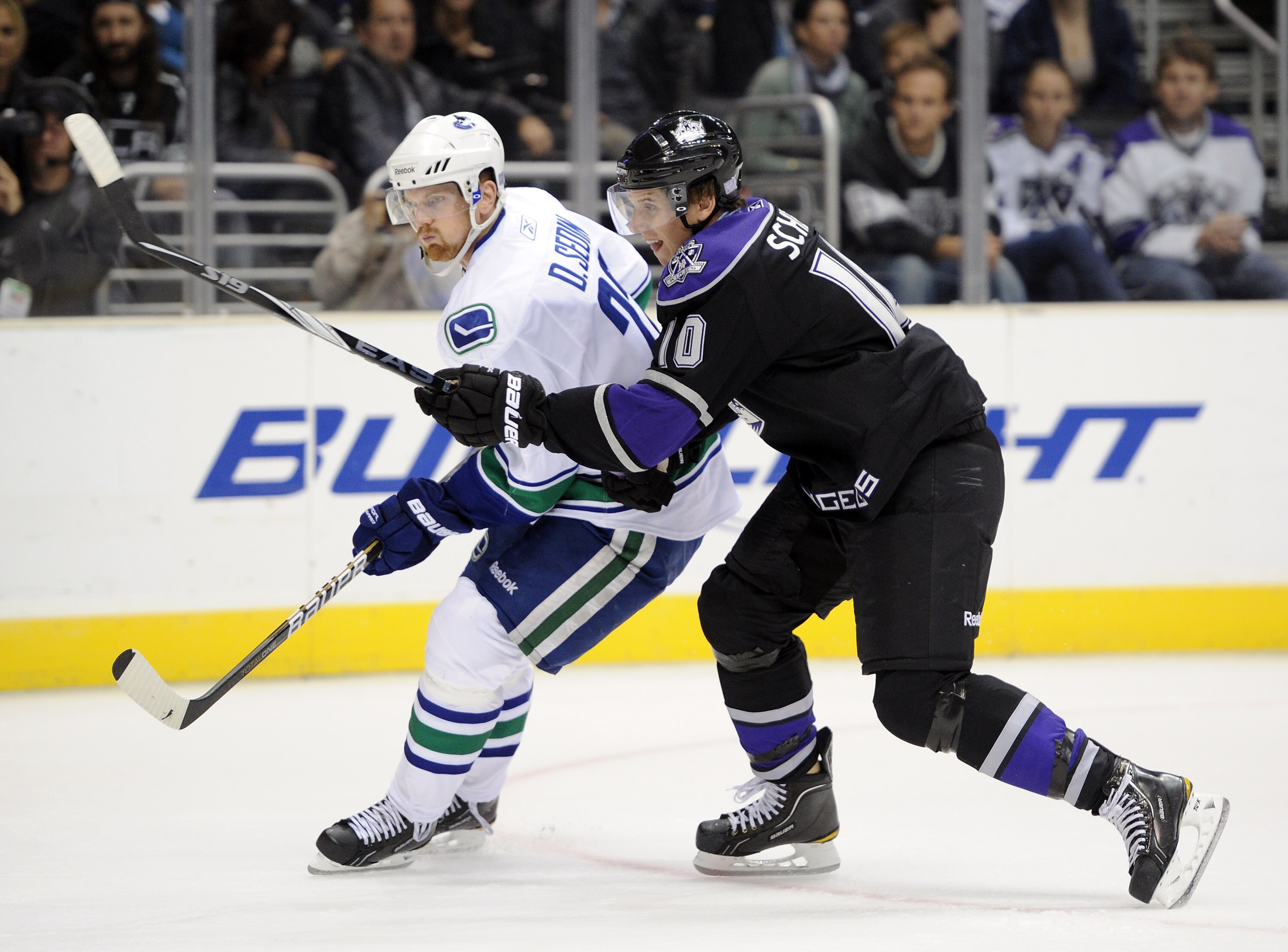 LOS ANGELES, CA - OCTOBER 15:  Brayden Schenn #10 of the Los Angeles Kings defends Daniel Sedin #22 of the Vancouver Canucks at the Staples Center on October 15, 2010 in Los Angeles, California.  (Photo by Harry How/Getty Images)
