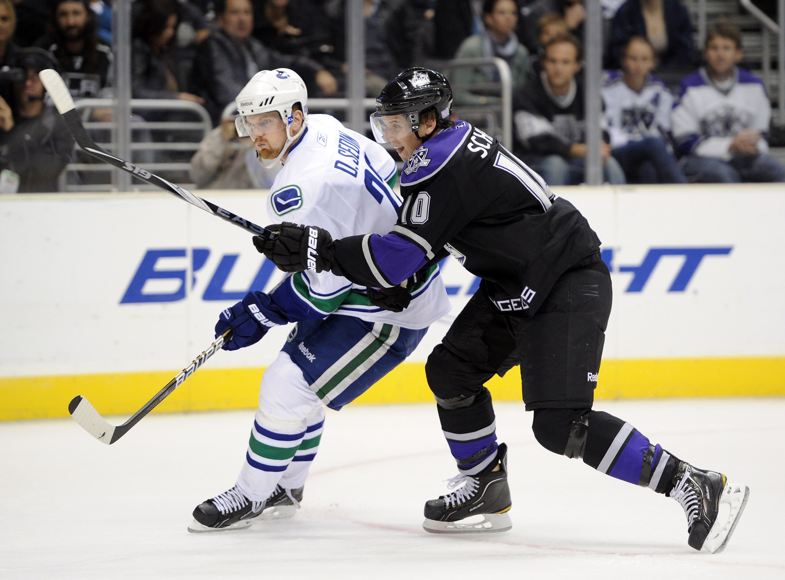 LOS ANGELES, CA - OCTOBER 15:  Brayden Schenn #10 of the Los Angeles Kings defends Daniel Sedin #22 of the Vancouver Canucks at the Staples Center on October 15, 2010 in Los Angeles, California.  (Photo by Harry How/Getty Images)