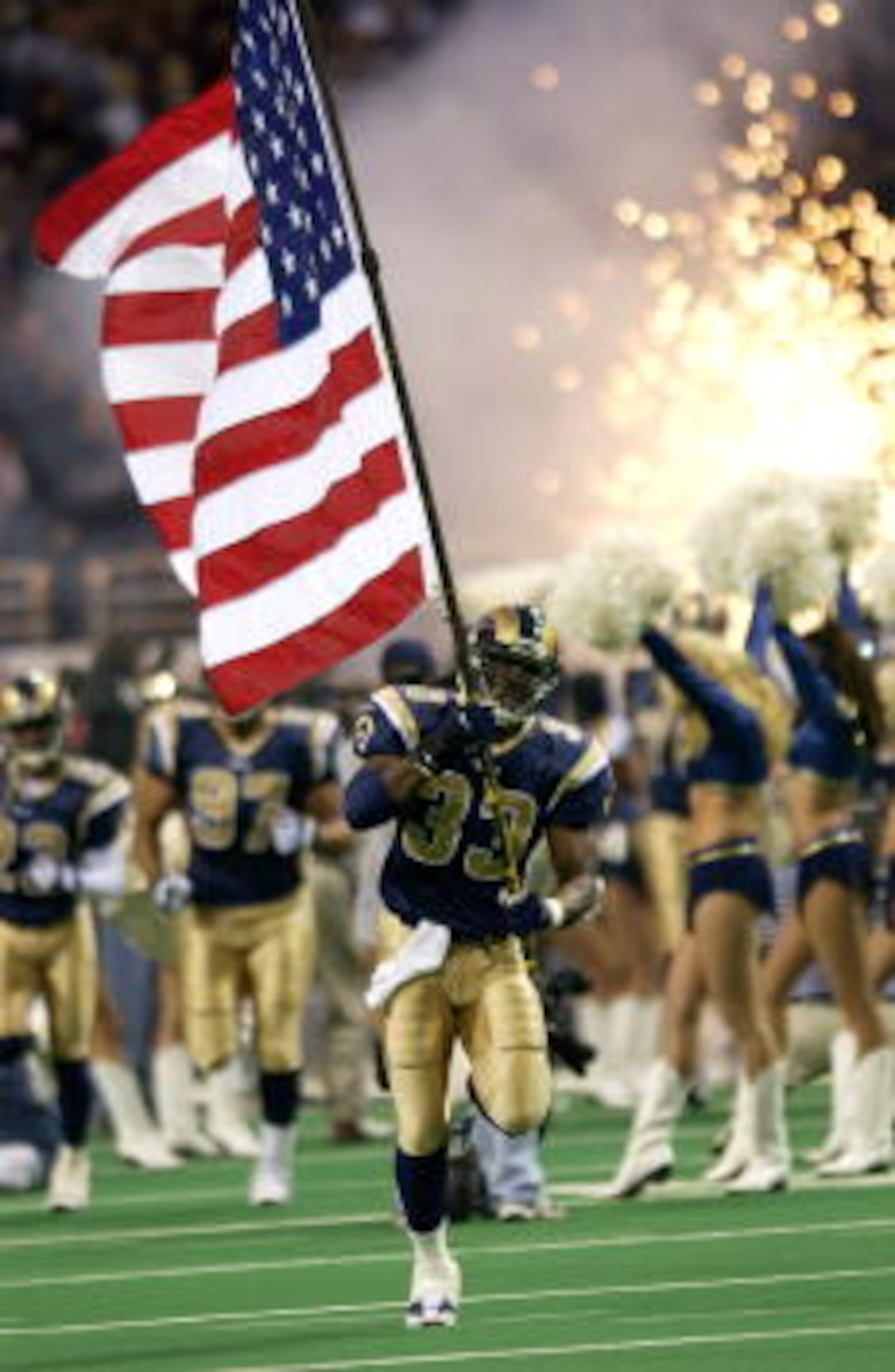 26 Nov 2001 : Justin Watson #33 of the St.Louis Rams carries a flag as he enters the field during pre-game ceremonies at the game against the Tampa Bay Buccaneers at the Dome at the America's Center in St.Louis, Missouri. The buccaneers won 24 - 17. DIGIT