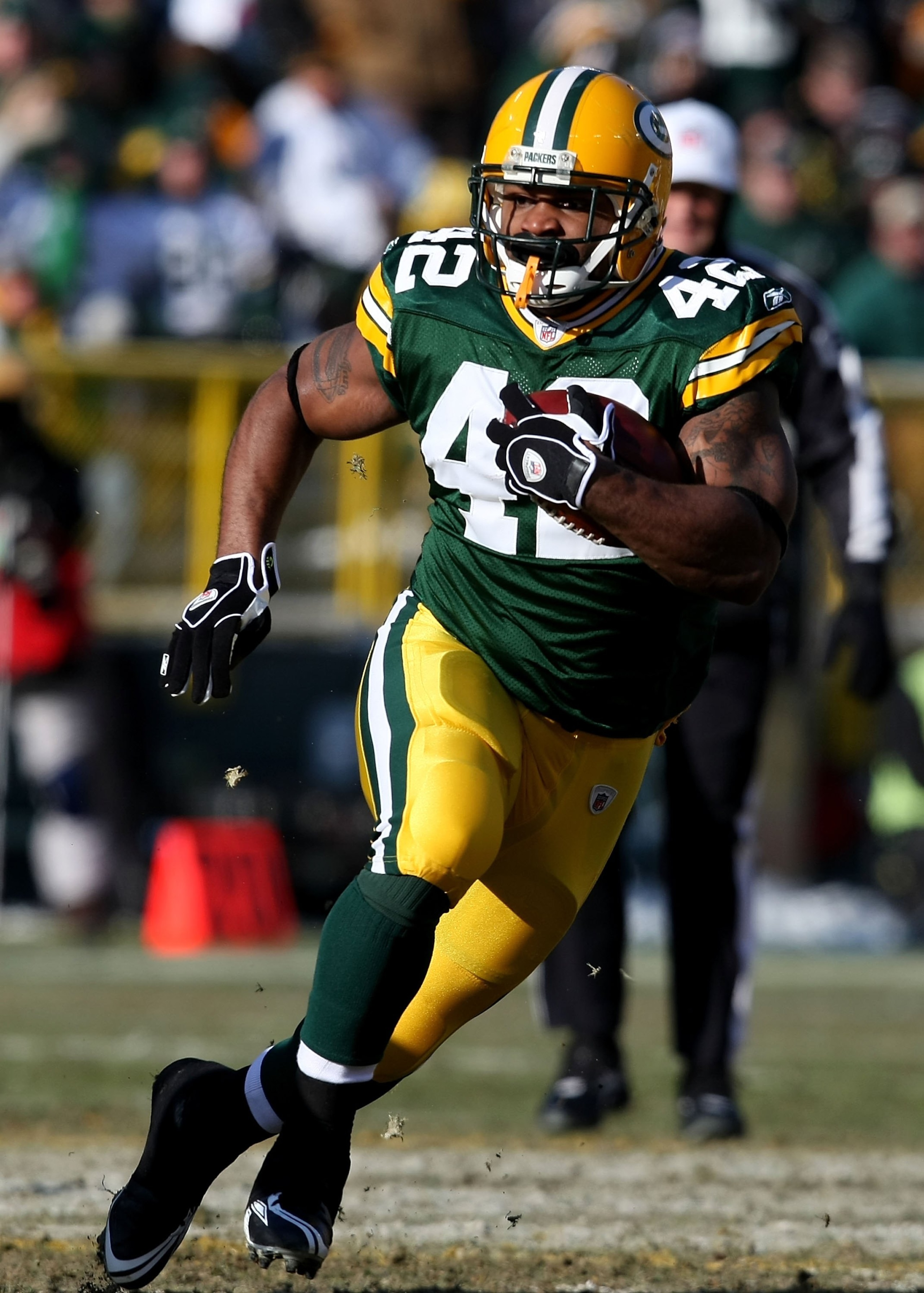 GREEN BAY, WI - DECEMBER 28: DeShawn Wynn #42 of the Green Bay Packers runs for a first down against the Detroit Lions on December 28, 2008 at Lambeau Field in Green Bay, Wisconsin. The Packers defeated the Lions 31-21. (Photo by Jonathan Daniel/Getty Ima