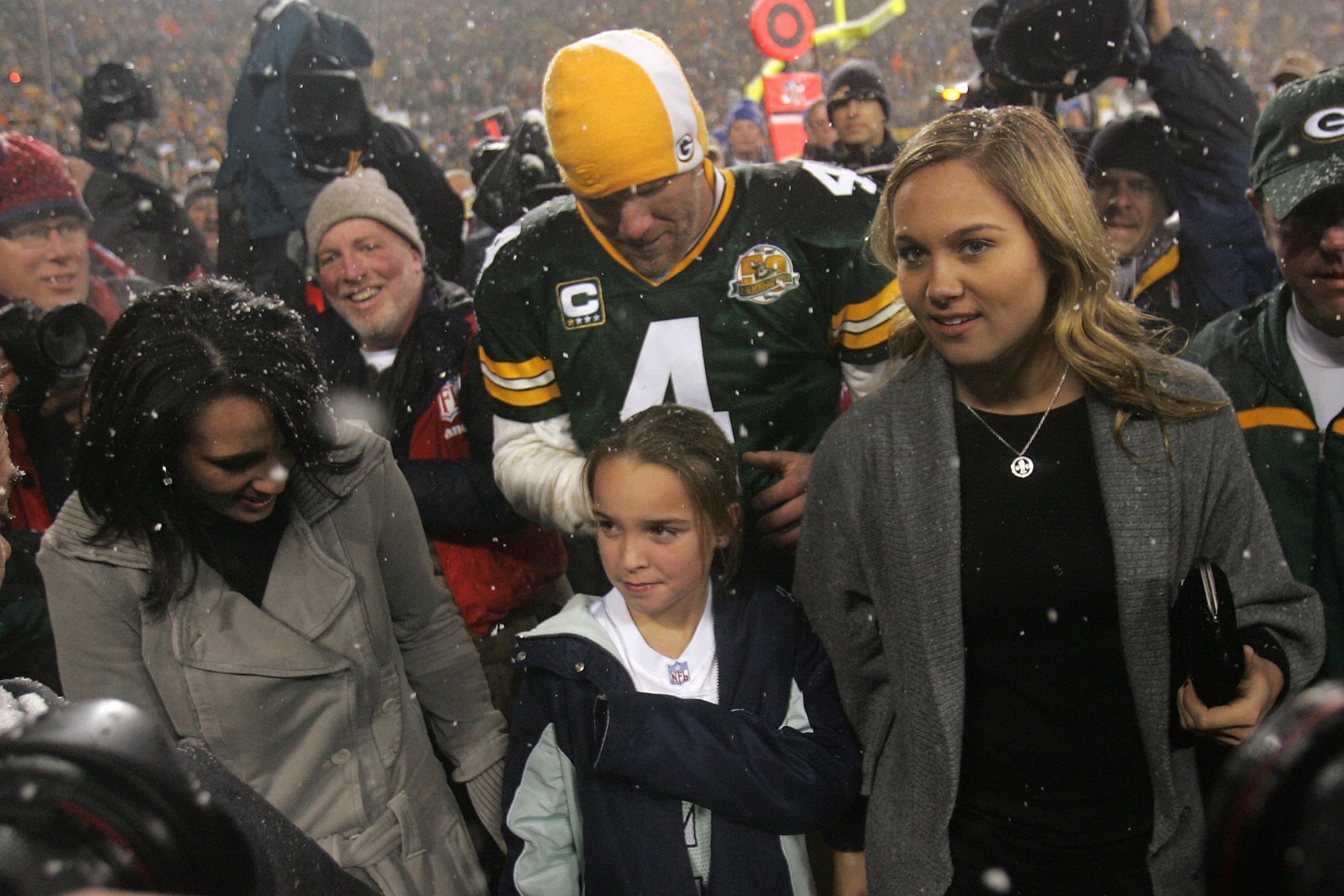 GREEN BAY, WI - JANUARY 12:  Quarterback Brett Favre #4 of the Green Bay Packers walks off the field with his wife Deanna and daughters (R) Brittany and (M) Breleigh after the Packers defeated the Seattle Seahawks 42-20 after the NFC divisional playoff ga