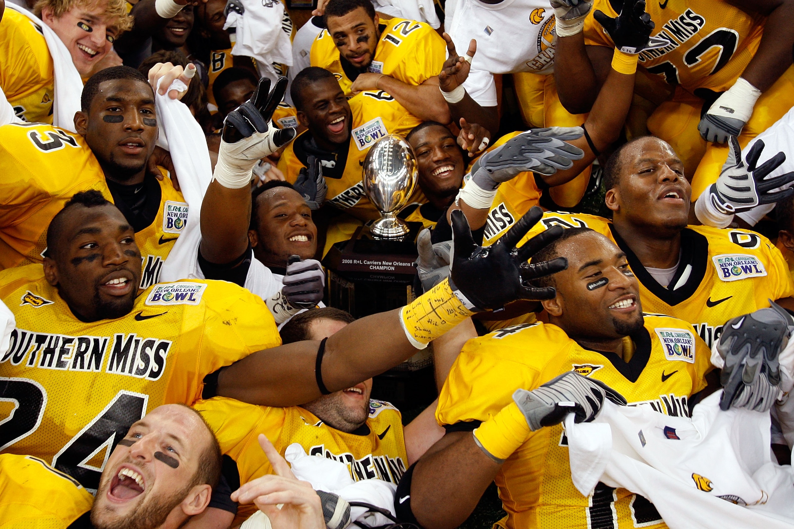 NEW ORLEANS - DECEMBER 21: Members of the Southern Mississippi Golden Eagles celebrate after defeating the Troy Trojans in overtime to win the R+L Carriers New Orleans Bowl on December 21, 2008 at the Superdome in New Orleans, Louisiana. (Photo by Chris G