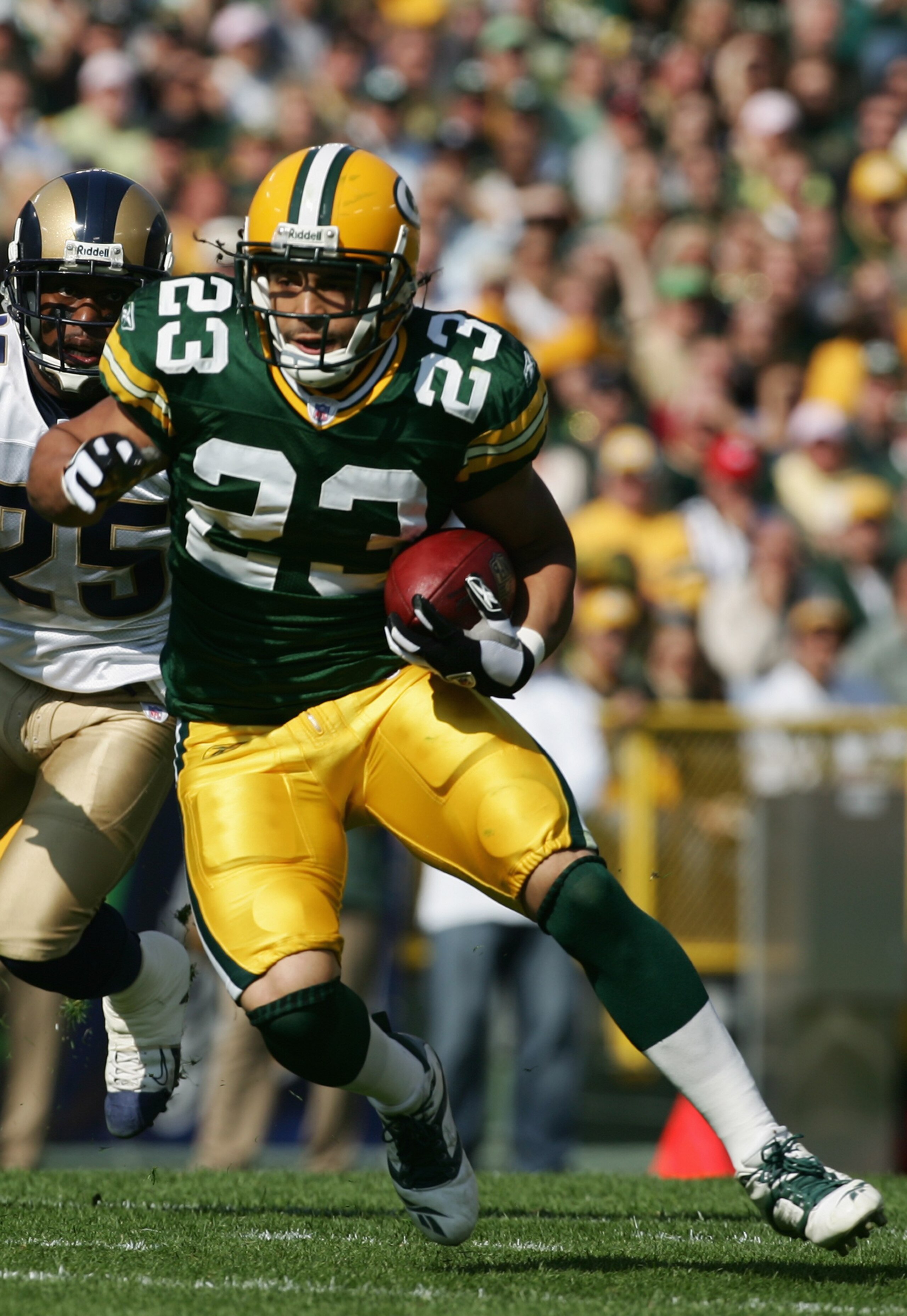 GREEN BAY, WI - OCTOBER 8:  Running back Noah Herron #23 of the Green Bay Packers runs with the ball against the St. Louis Rams at Lambeau Field on October 8, 2006 in Green Bay, Wisconsin. The Rams defeated the Packers 23-20.  (Photo by Harry How/Getty Im