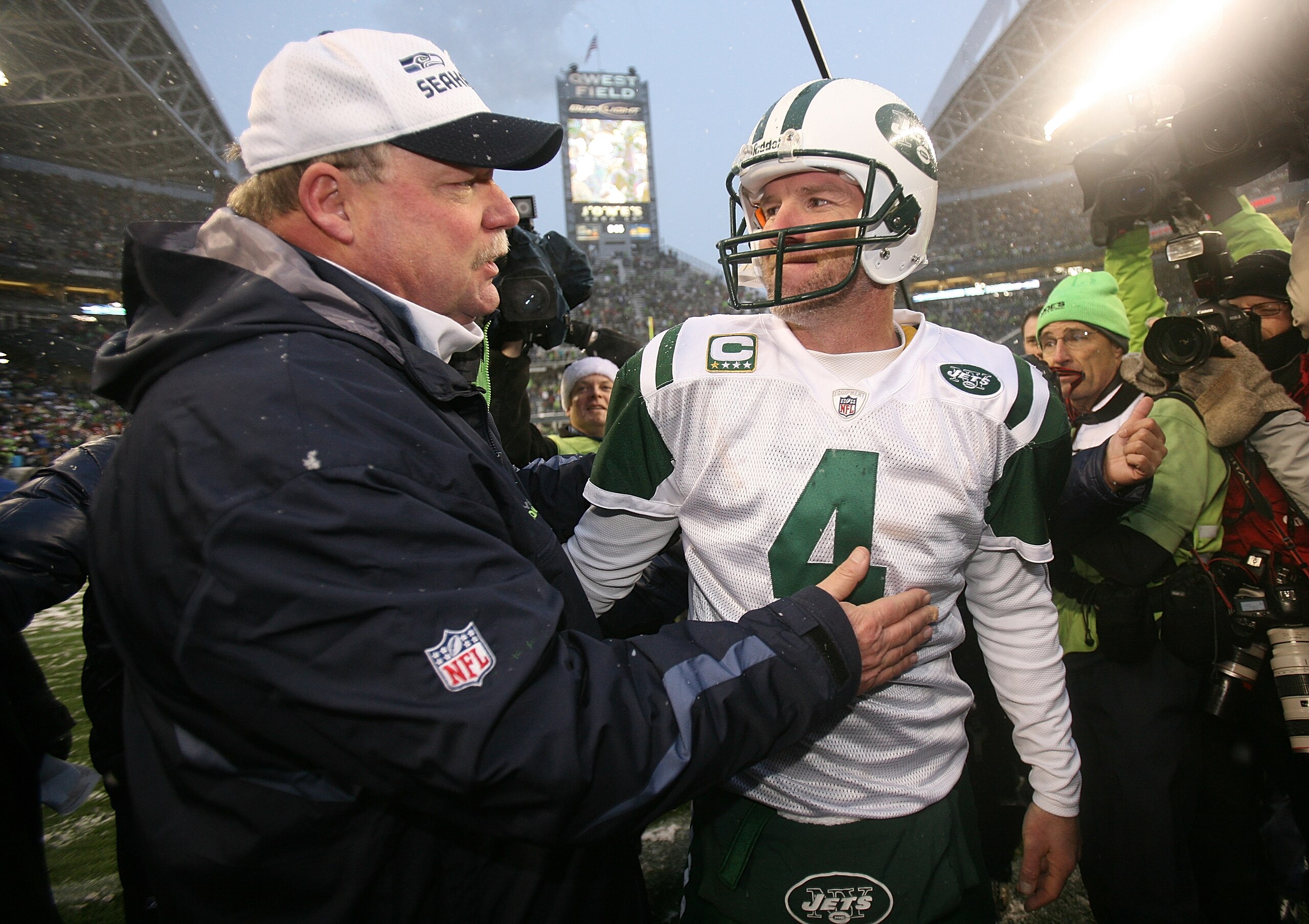 SEATTLE - DECEMBER 21:  Head coach Mike Holmgrem of the Seattle Seahawks is congratulated by quarterback Brett Favre #4 of New York Jets on December 21, 2008 at Qwest Field in Seattle, Washington. The Seahawks defeated the Jets 13-3. (Photo by Otto Greule