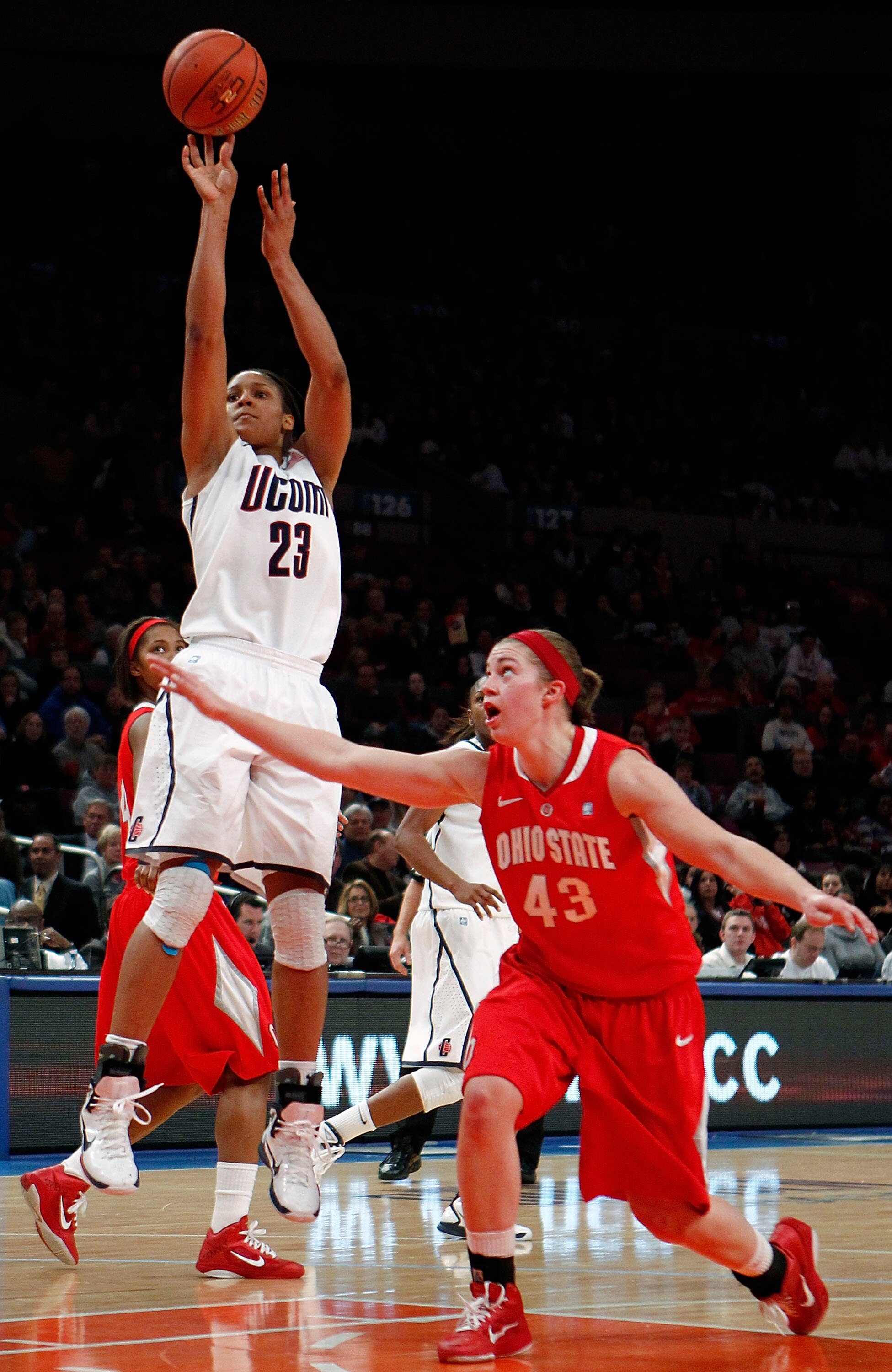 NEW YORK, NY - DECEMBER 19:  Maya Moore #23 of the Connecticut Huskies takes a jump shot over Sarah Schulze #43 pf the  Ohio State Buckeyes in the Maggie Dixon Classic at Madison Square Garden on December 19, 2010 in New York City.  (Photo by Jeff Zelevan
