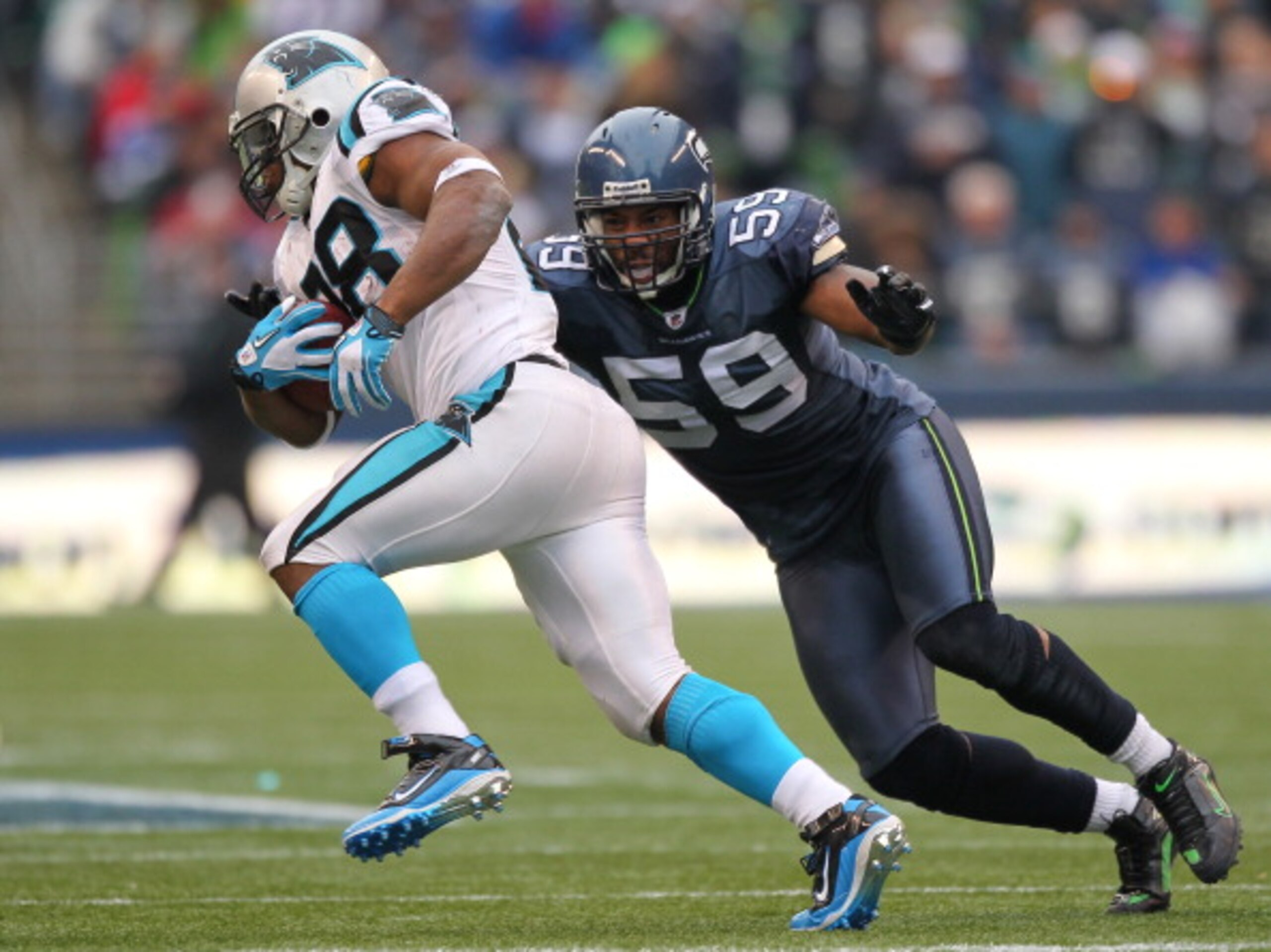 SEATTLE - DECEMBER 05:  Running back Jonathan Stewart #28 of the Carolina Panthers rushes against Aaron Curry #59 of the Seattle Seahawks at Qwest Field on December 5, 2010 in Seattle, Washington. The Seahawks won, 31-14. (Photo by Otto Greule Jr/Getty Im