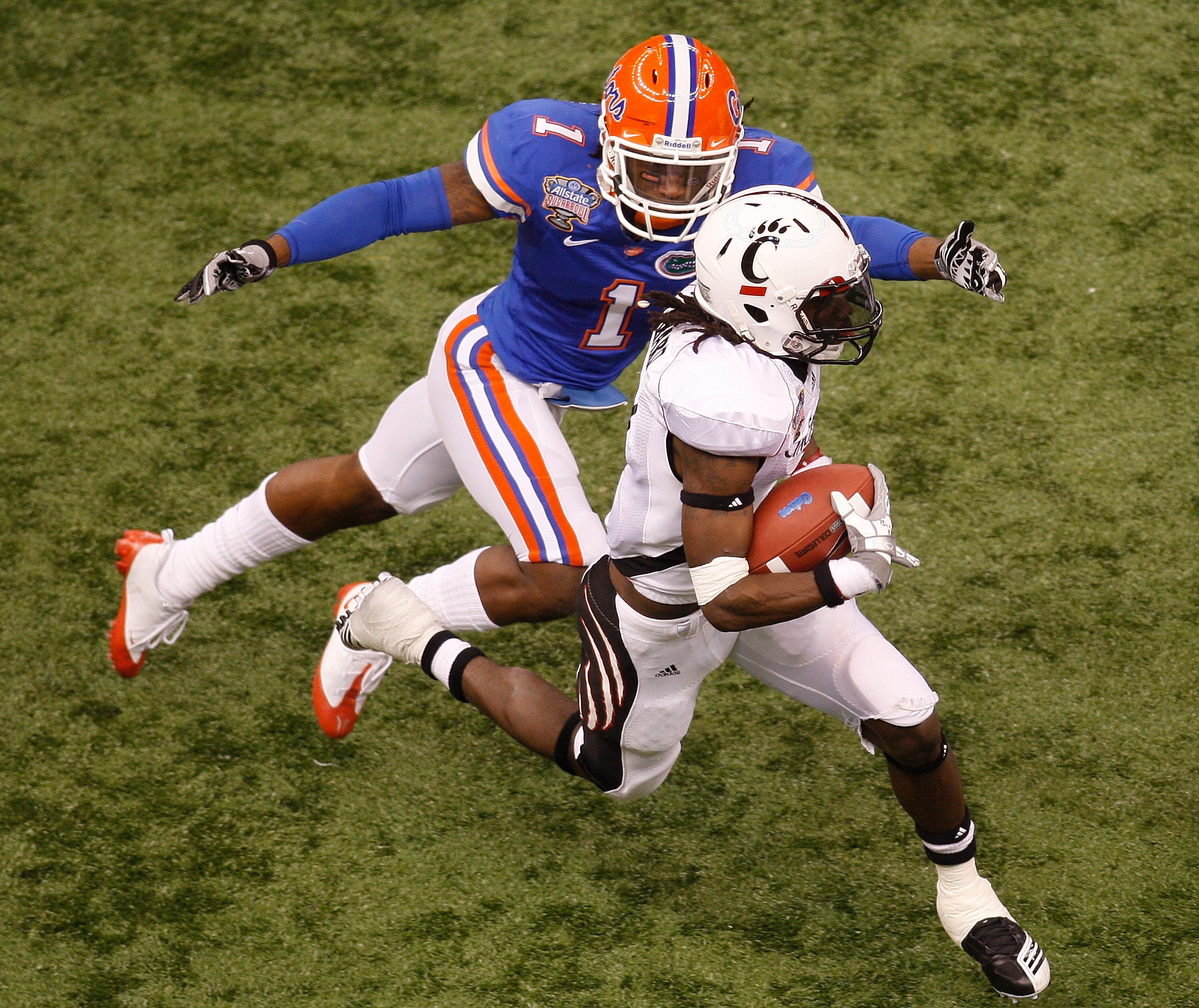 NEW ORLEANS - JANUARY 01:  Mardy Gilyard #1 of the Cincinnati Bearcats is tackled by Janoris Jenkins #1 of the Florida Gators during the Allstate Sugar Bowl at the Louisana Superdome on January 1, 2010 in New Orleans, Louisiana.  (Photo by Chris Graythen/