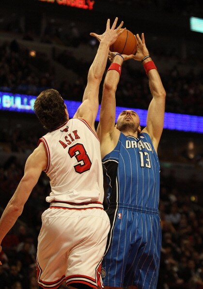 CHICAGO, IL - DECEMBER 01: Omer Asik #3 of the Chicago Bulls blocks a shot by Marcin Gortat #13 of the Orlando Magic at the United Center on December 1, 2010 in Chicago, Illinois. NOTE TO USER: User expressly acknowledges and agrees that, by downloading a