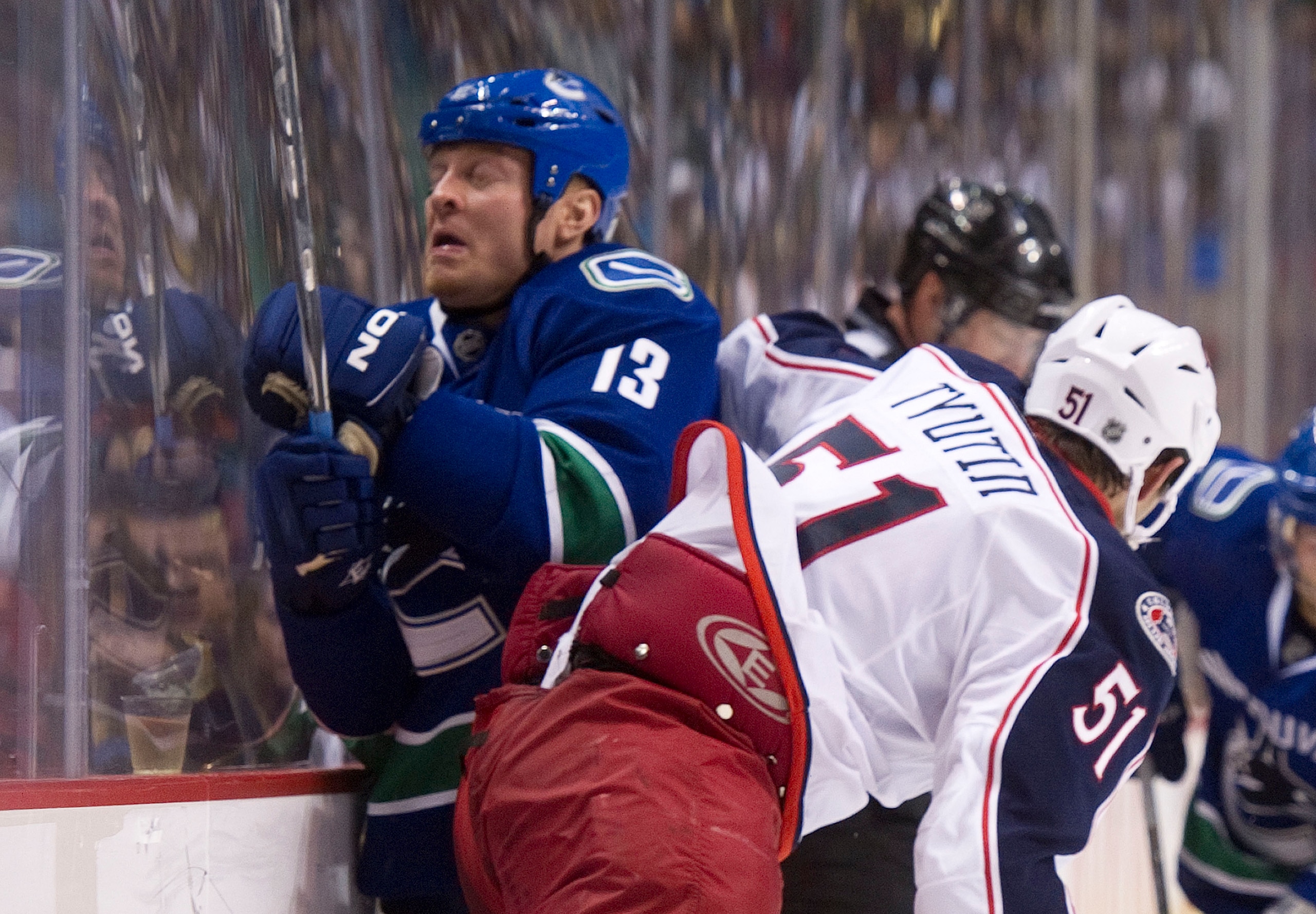 VANCOUVER, CANADA - DECEMBER 15: Raffi Torres #13 of the Vancouver Canucks reacts as he is taken into the boards by Fedor Tyutin #51 of the Columbus Blue Jackets during the second period in NHL action on December 15, 2010 at Rogers Arena in Vancouver, BC,
