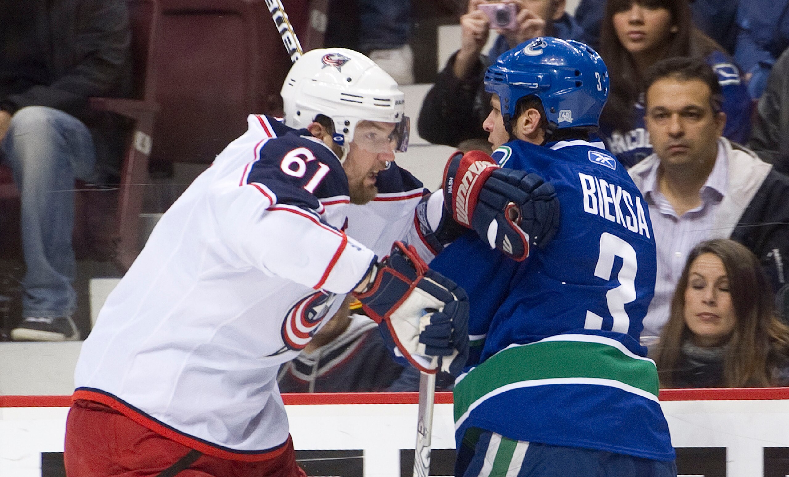 VANCOUVER, CANADA - DECEMBER 15: Kevin Bieksa #3 of the Vancouver Canucks braces for a hit by Rick Nash #61 of the Columbus Blue Jackets during the first period in NHL action on December 15, 2010 at Rogers Arena in Vancouver, BC, Canada.  (Photo by Rich L