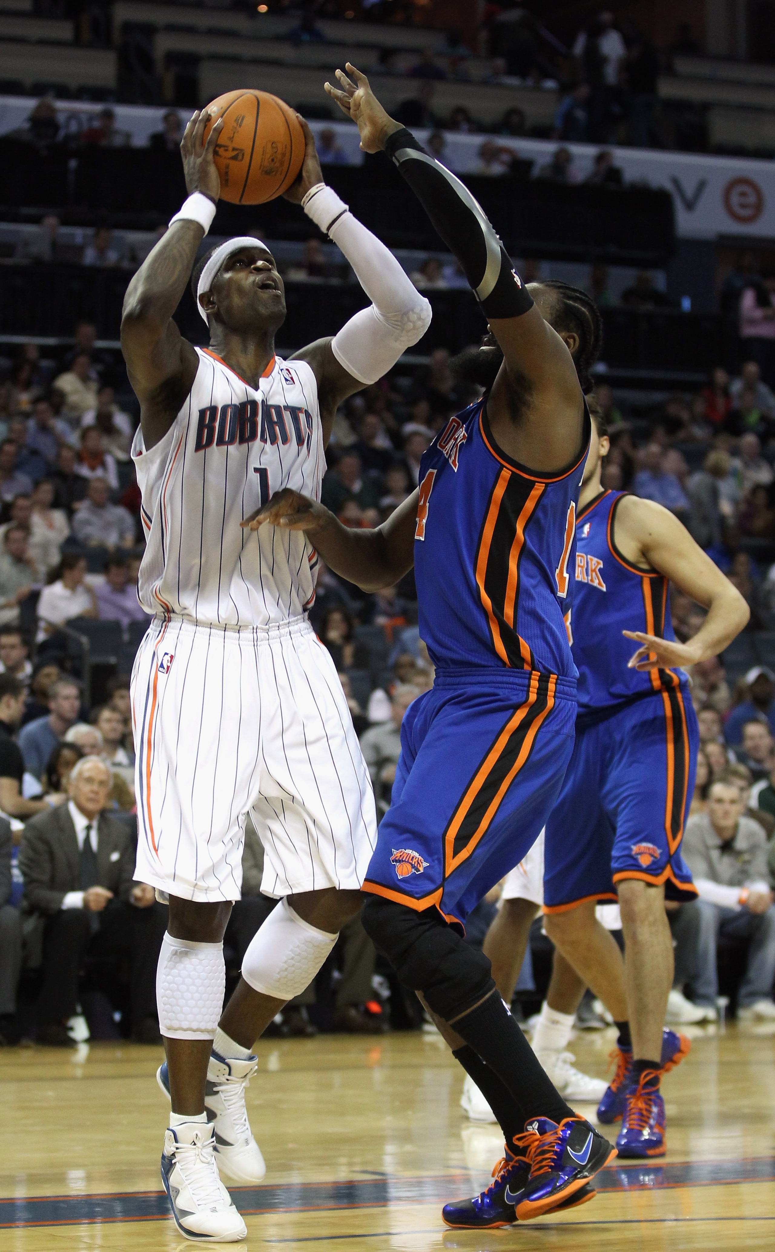 CHARLOTTE, NC - NOVEMBER 24:  Ronny Turiaf #14 of the New York Knicks tries to stop Stephen Jackson #1 of the Charlotte Bobcats during their game at Time Warner Cable Arena on November 24, 2010 in Charlotte, North Carolina.  NOTE TO USER: User expressly a