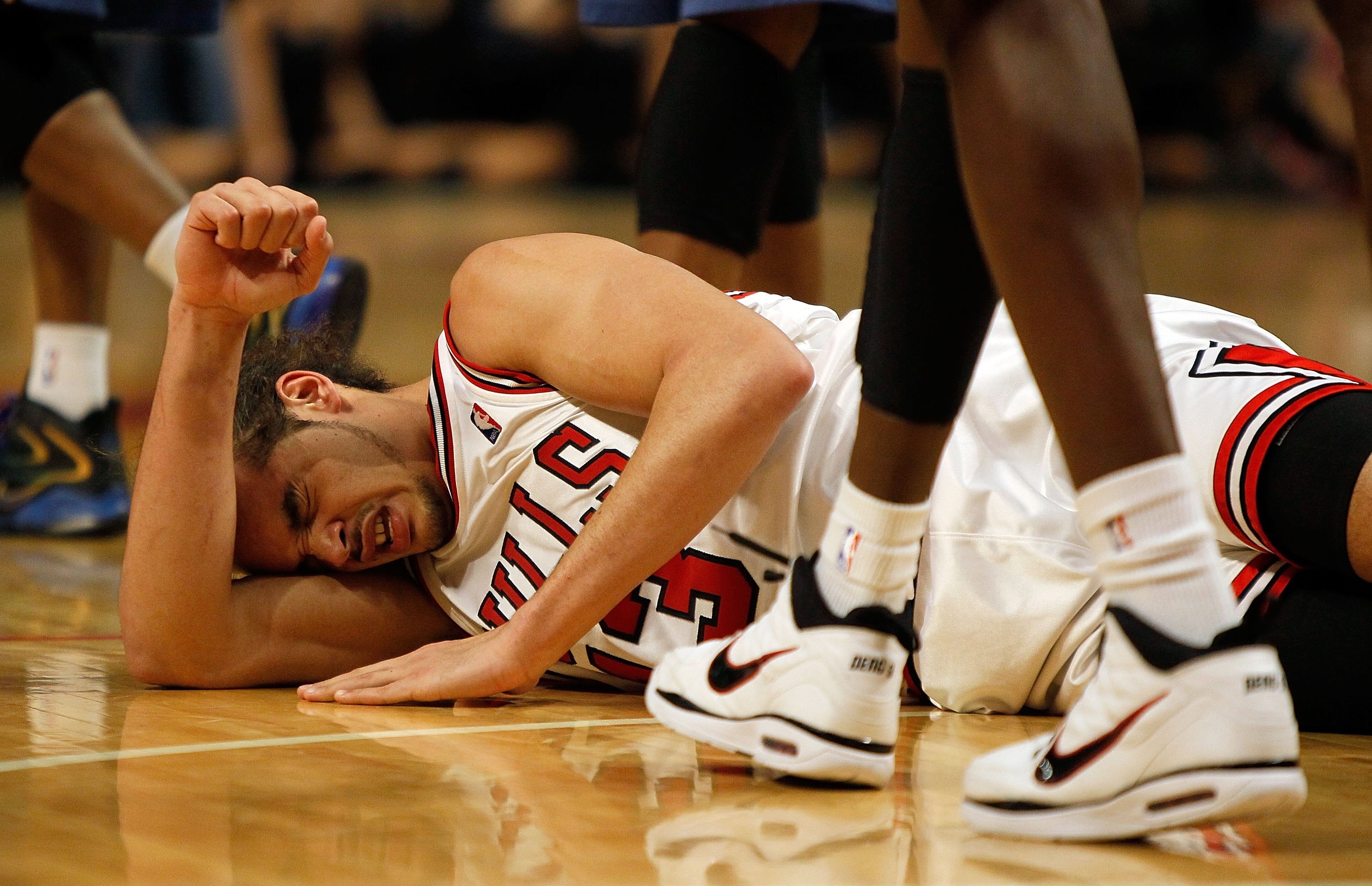 CHICAGO - JANUARY 15: Joakim Noah #13 of the Chicago Bulls lays on the floor after suffering an injury against the Washington Wizards at the United Center on January 15, 2010 in Chicago, Illinois. The Bulls defeated the Wizards 121-119 in double overtime.