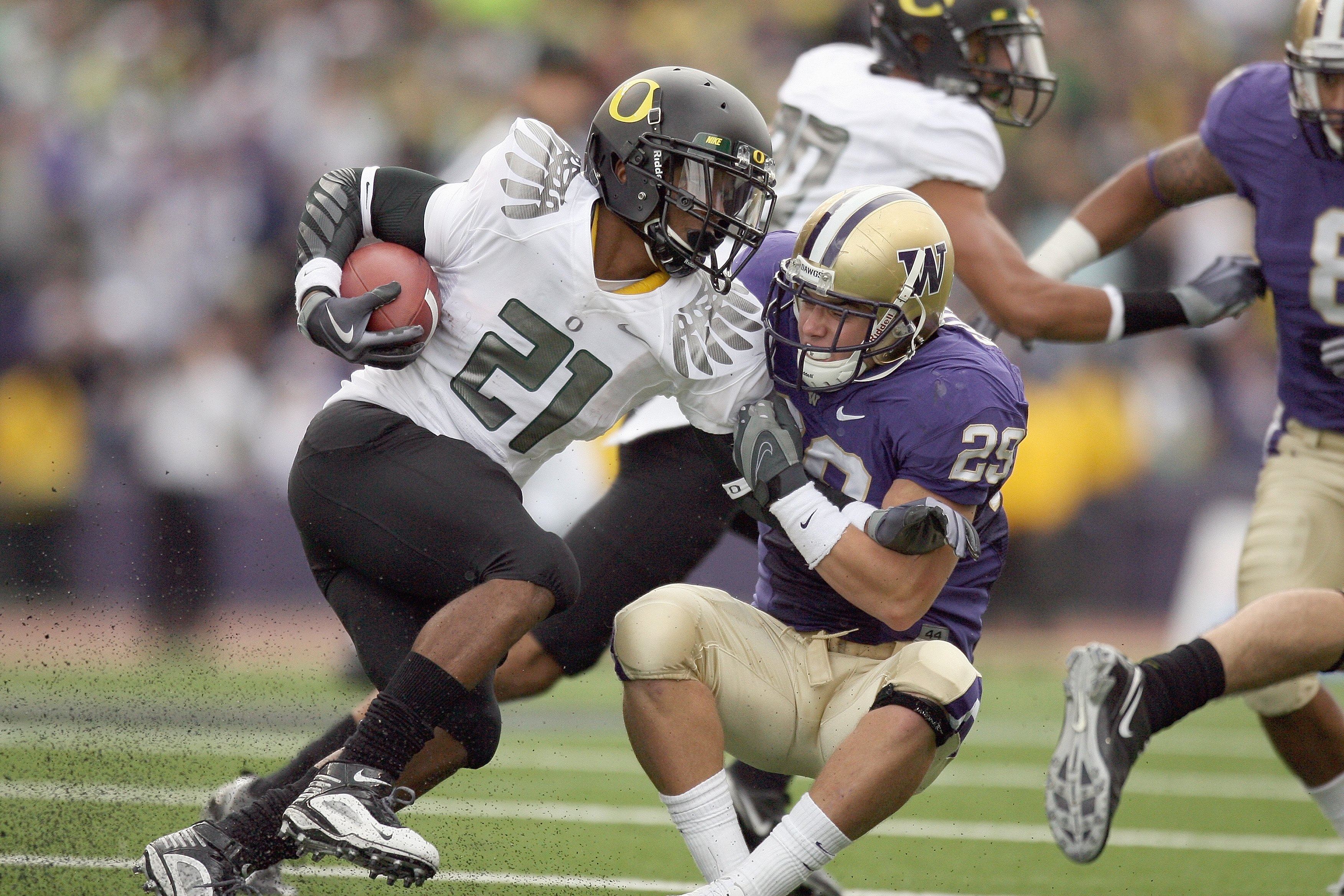 SEATTLE - OCTOBER 24:  LaMichael James #21 of the Oregon Ducks carries the ball against Nate Fellner #29 of the Washington Huskies on October 24, 2009 at Husky Stadium in Seattle, Washington. The Ducks defeated the Huskies 43-19. (Photo by Otto Greule Jr/