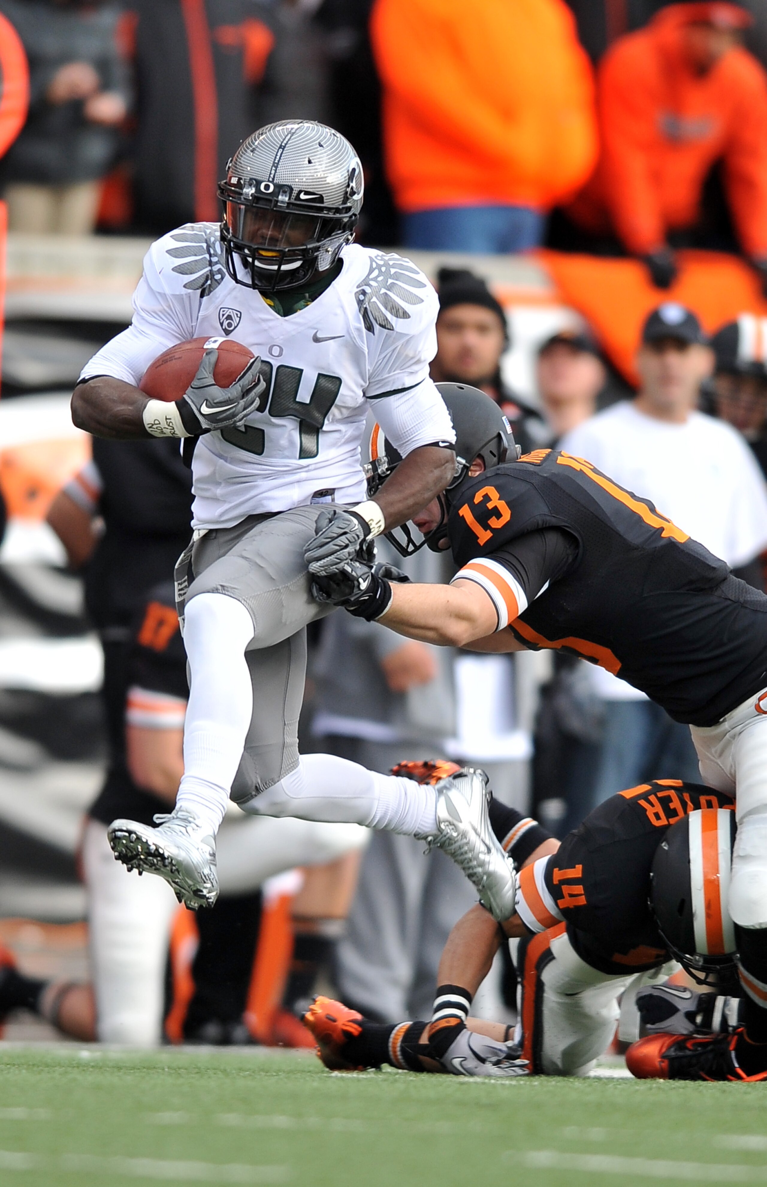 CORVALLIS, OR - DECEMBER 4: Kenjon Barner #24 of the Oregon Ducks avoids the tackle of Rueben Robinson #13 of the Oregon State Beavers in the second quarter of the game at Reser Stadium on December 4, 2010 in Corvallis, Oregon. (Photo by Steve Dykes/Getty