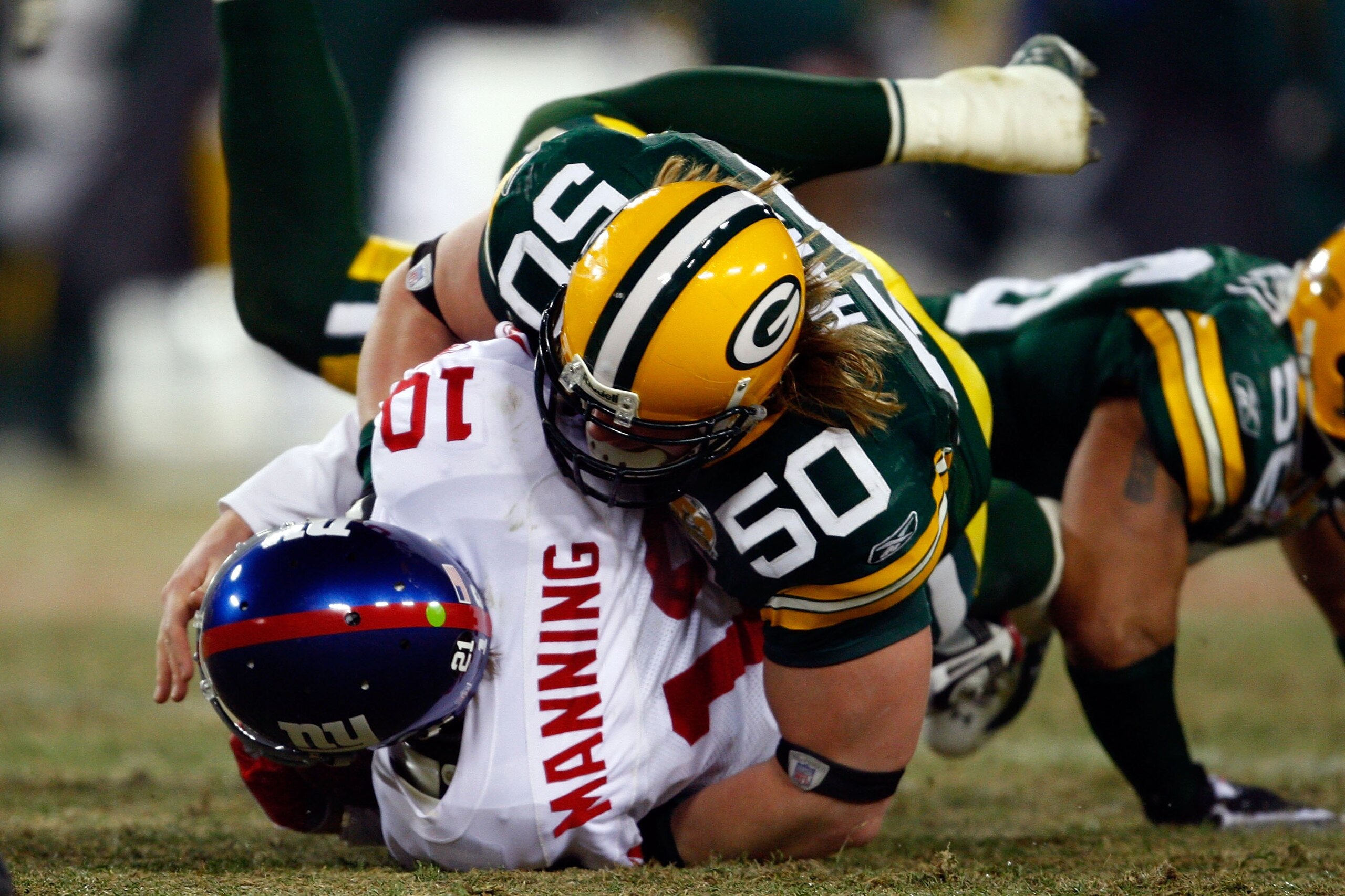 GREEN BAY, WI - JANUARY 20:  Linebacker AJ Hawk #50 of the Green Bay Packers sacks quarterback Eli Manning #10 of the New York Giants during the NFC championship game on January 20, 2008 at Lambeau Field in Green Bay, Wisconsin. The Giants defeated the Pa