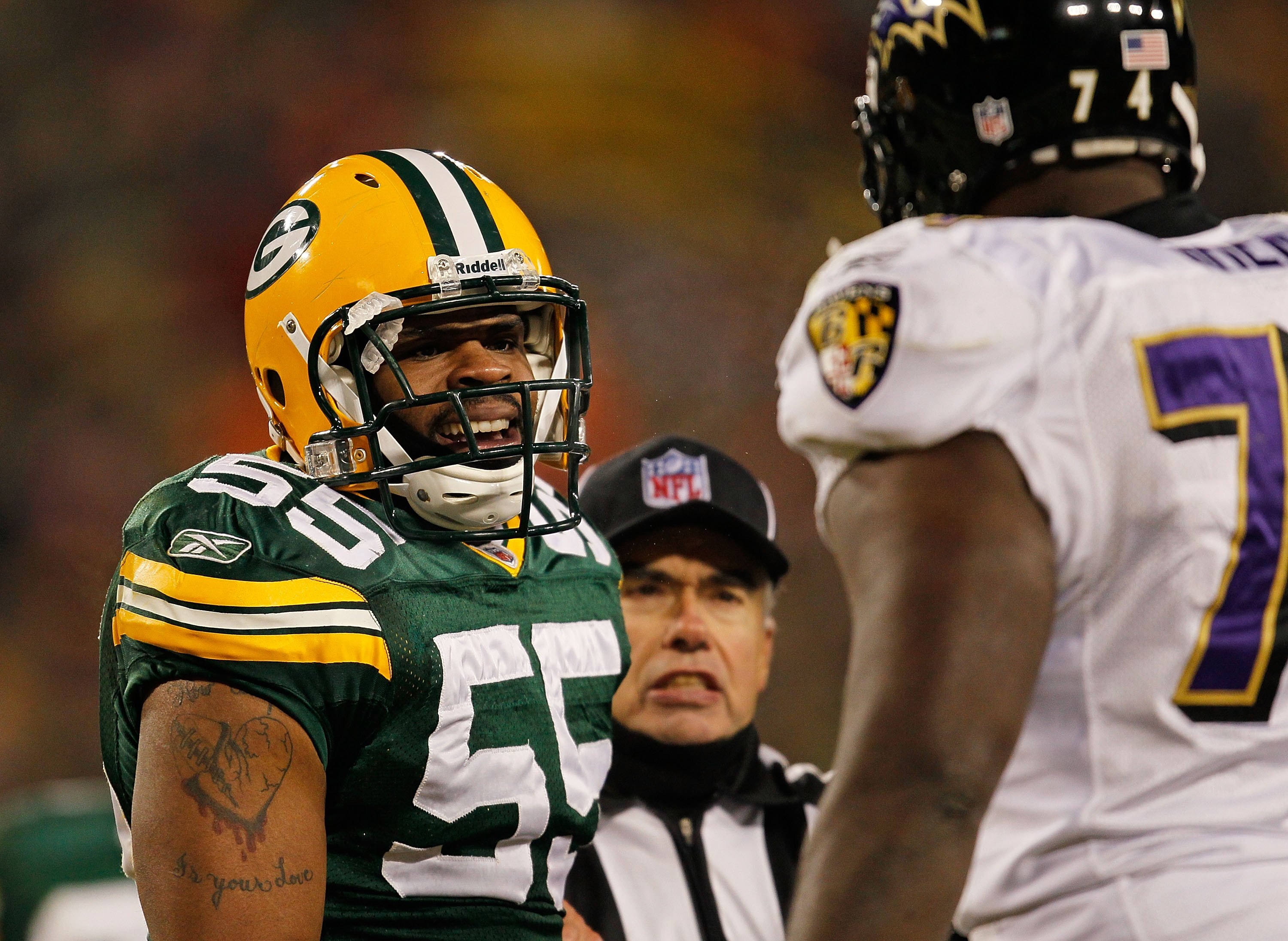 GREEN BAY, WI - DECEMBER 07: Desmond Bishop #55 of the Green Bay Packers has words with Michael Oher #74 of the Baltimore Ravens at Lambeau Field on December 7, 2009 in Green Bay, Wisconsin. The Packers defeated the Ravens 27-17. (Photo by Jonathan Daniel