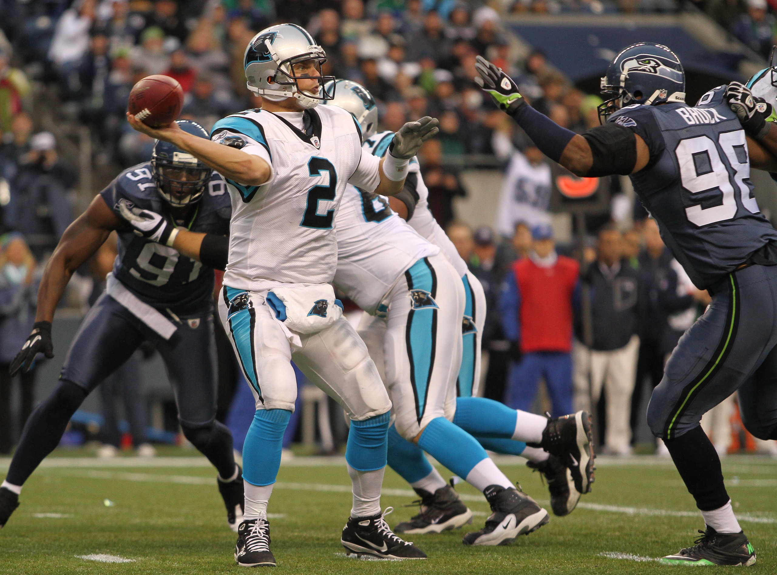 SEATTLE - DECEMBER 05:  Quarterback Jimmy Clausen #2 of the Carolina Panthers passes against Raheem Brock #98 of the Seattle Seahawks at Qwest Field on December 5, 2010 in Seattle, Washington. The Seahawks won, 31-14. (Photo by Otto Greule Jr/Getty Images