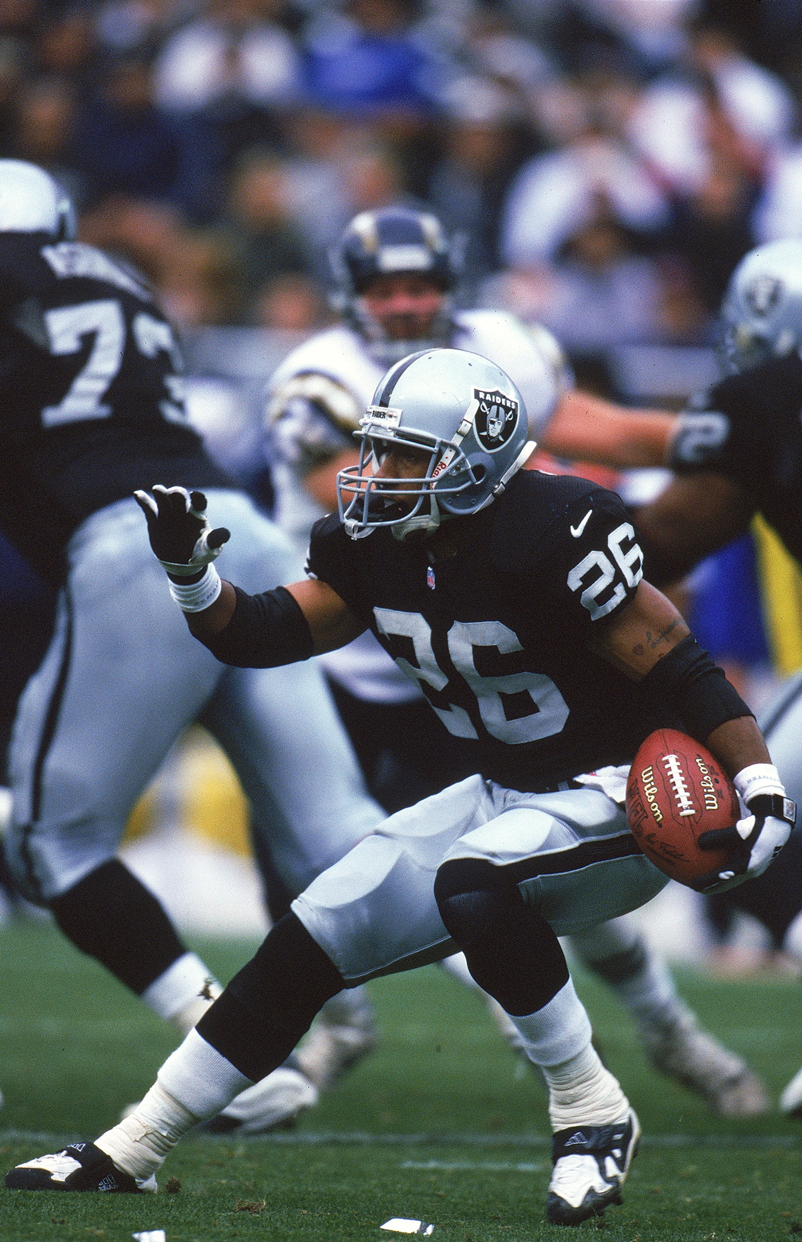 14 Nov 1999:  Napoleon Kaufman #26 of the Oakland Raiders in action during the game against the San Diego Chargers at the Network Associates Coliseum in Oakland, California. The Raiders defeated the Chargers 28-9. Mandatory Credit: Jed Jacobsohn  /Allspor