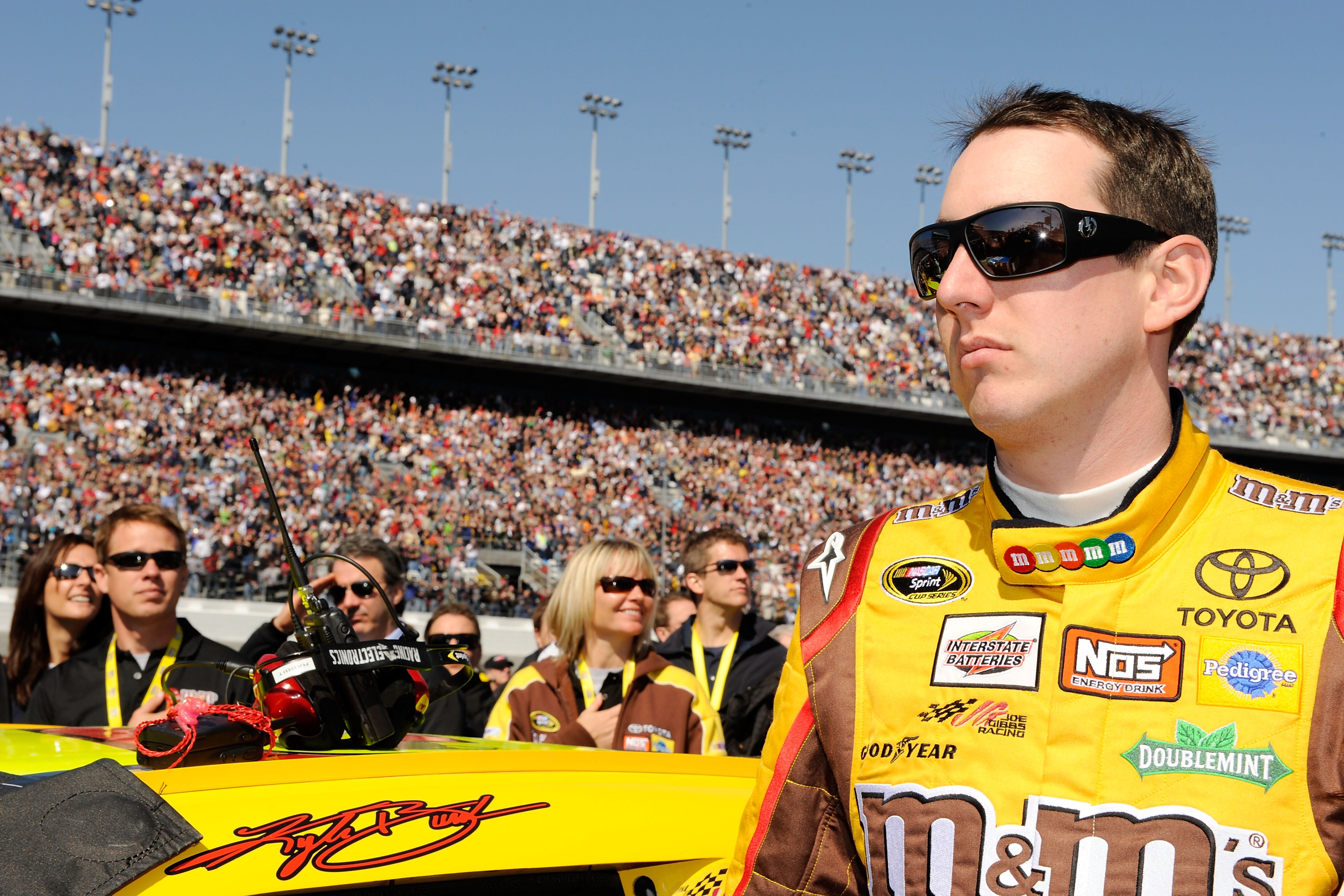 DAYTONA BEACH, FL - FEBRUARY 14:  Kyle Busch, driver of the #18 M&M's Toyota, stands on the grid prior to the NASCAR Sprint Cup Series Daytona 500 at Daytona International Speedway on February 14, 2010 in Daytona Beach, Florida.  (Photo by Rusty Jarrett/G