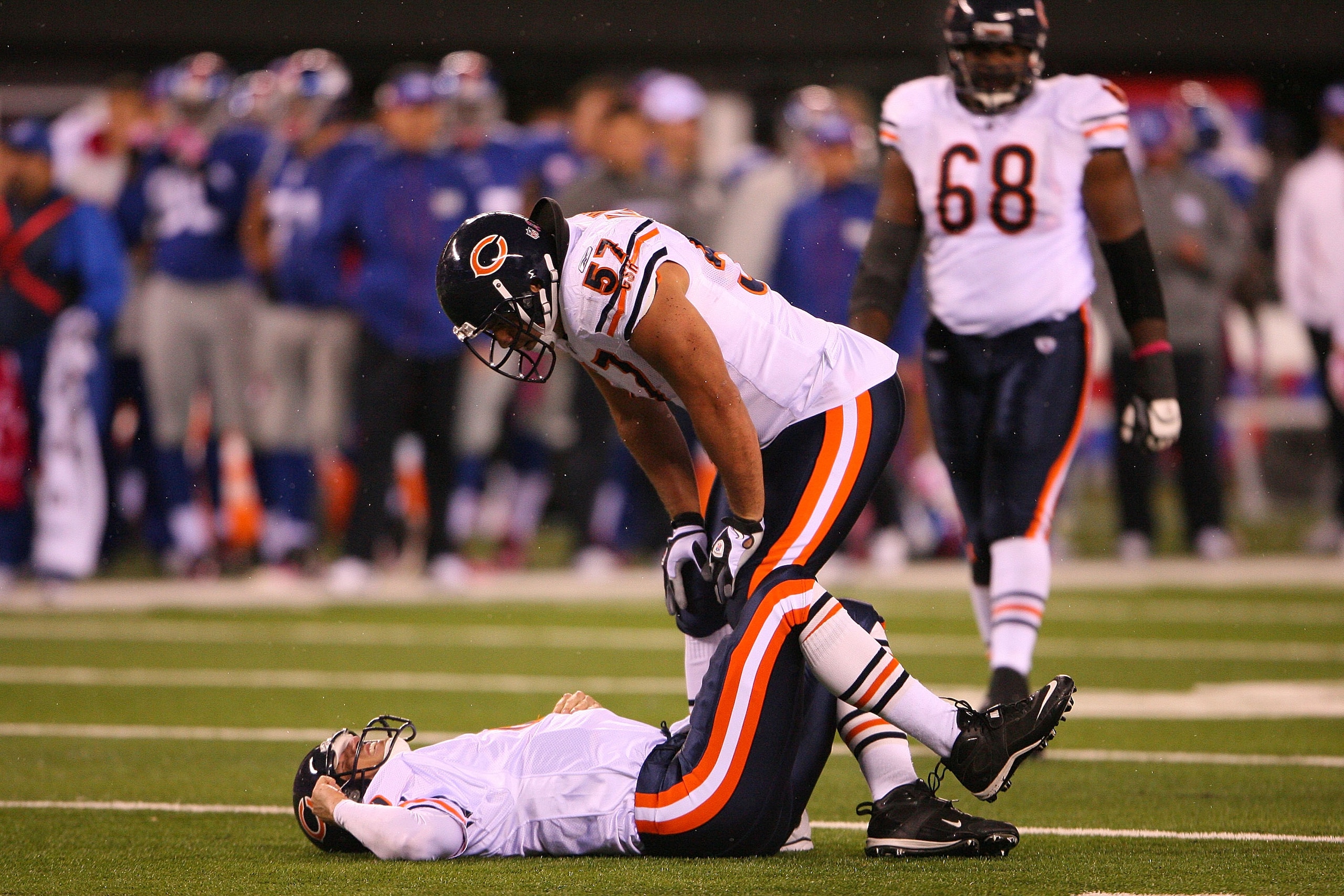 EAST RUTHERFORD, NJ - OCTOBER 03:  Olin Kreutz #57 looks at Todd Collins #10 of the Chicago Bears as he lays on the field after getting injured against the New York Giants at New Meadowlands Stadium on October 3, 2010 in East Rutherford, New Jersey.  (Pho