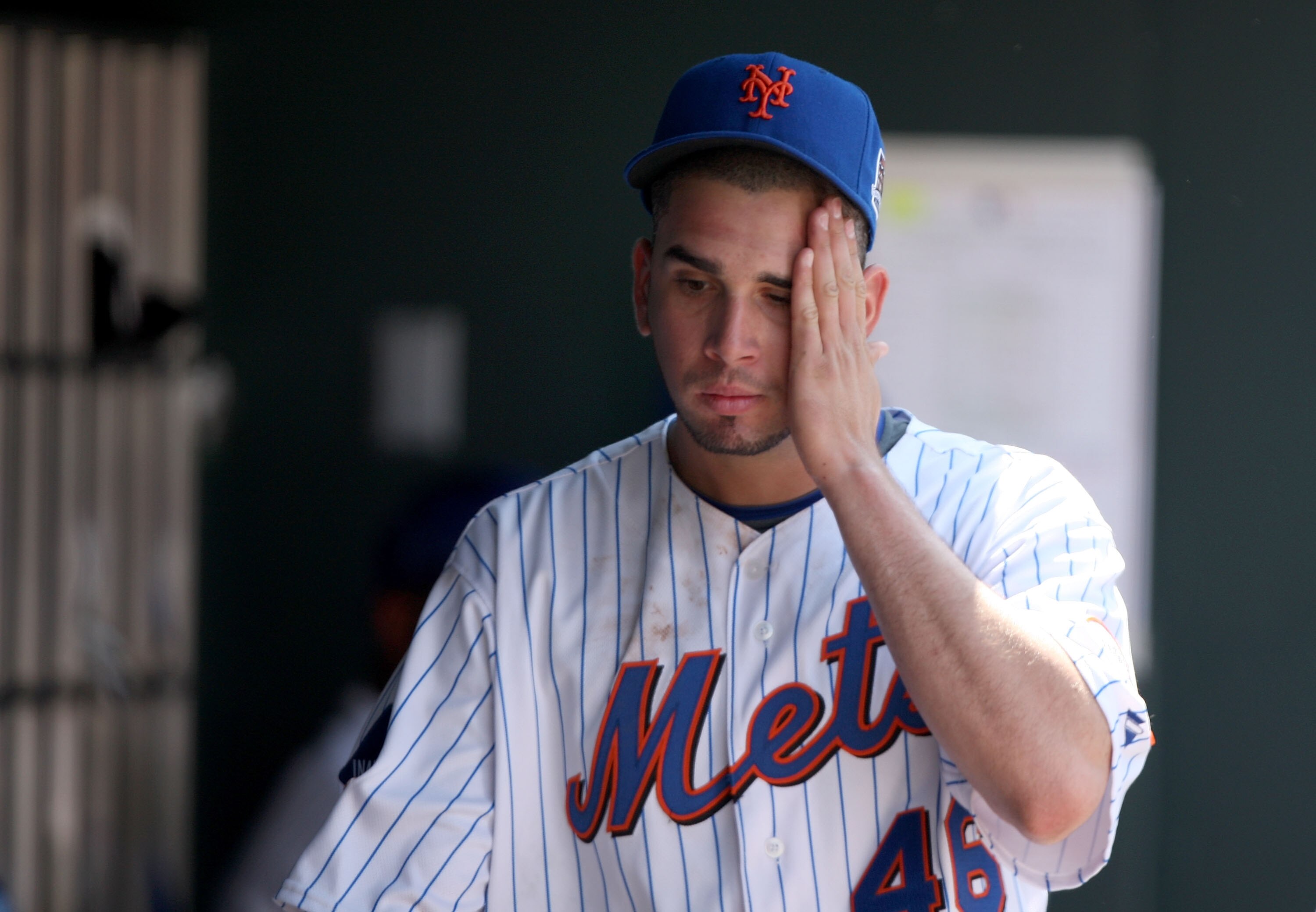 NEW YORK - APRIL 26:  Oliver Perez #46 of the New York Mets reacts in the dugout after he was taken out of their game against the Washington Nationals in the fifth inning on April 26, 2009 at Citi Field in the Flushing neighborhood of the Queens borough o