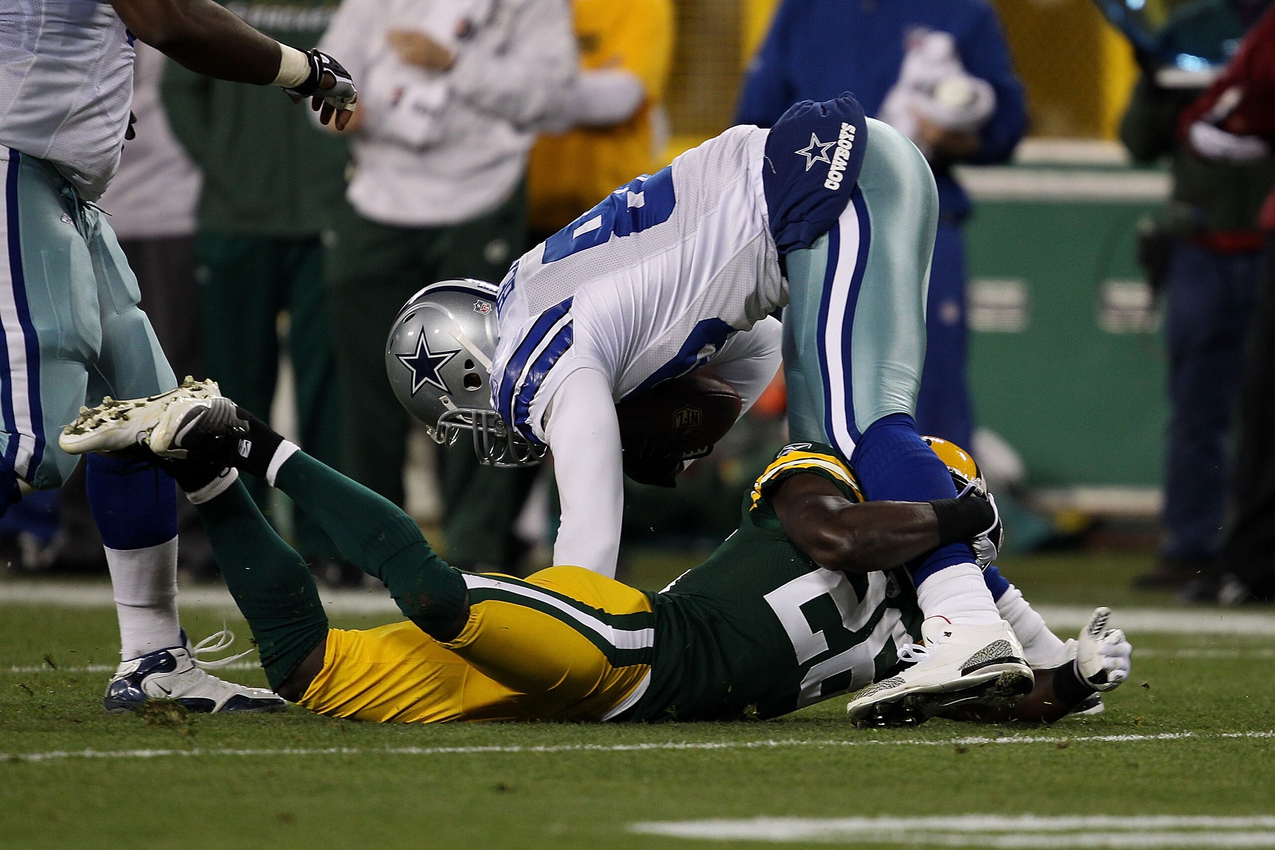 GREEN BAY, WI - NOVEMBER 07: Charlie Peprah #26 of the Green Bay Packers tackles Martellus Bennett #80 of the Dallas Cowboys at Lambeau Field on November 7, 2010 in Green Bay, Wisconsin. The Packers defeated the Cowboys 45-7. (Photo by Jonathan Daniel/Get
