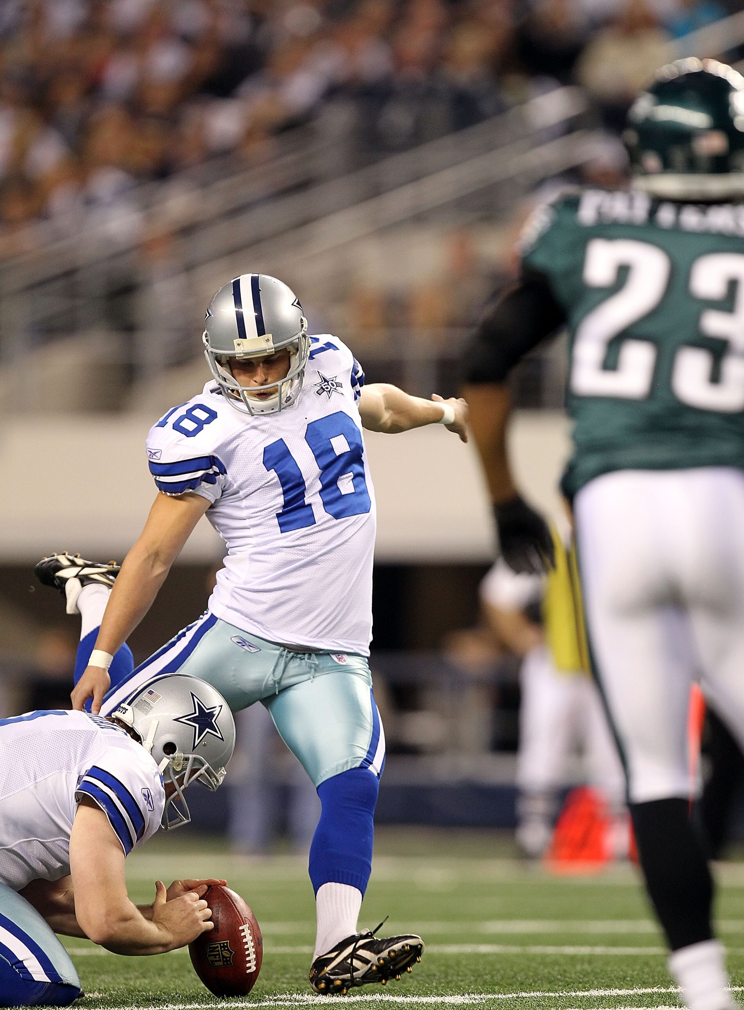 ARLINGTON, TX - DECEMBER 12:  Kicker David Buehler #18 of the Dallas Cowboys kicks a field goal against the Philadelphia Eagles at Cowboys Stadium on December 12, 2010 in Arlington, Texas.  (Photo by Ronald Martinez/Getty Images)