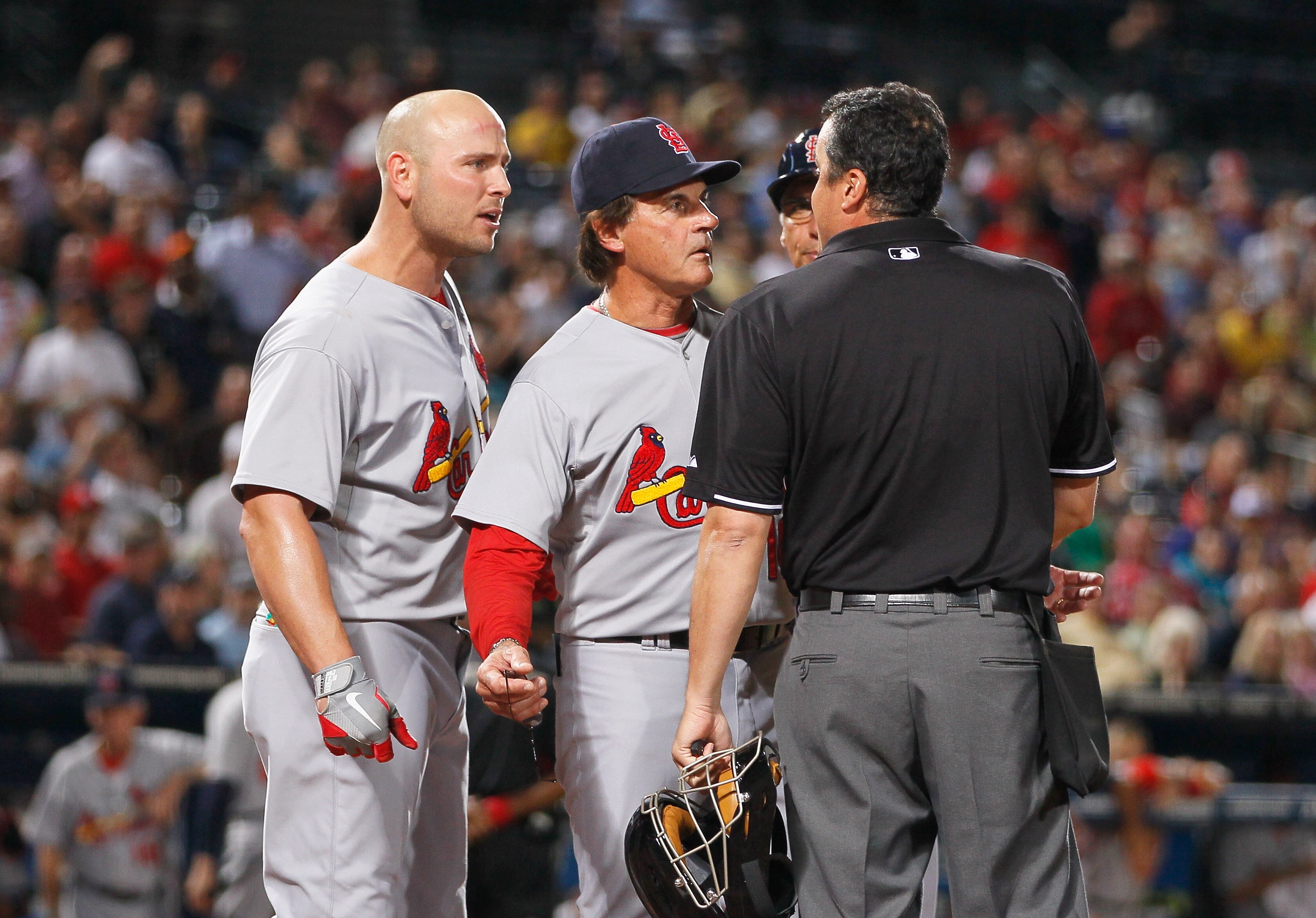 ATLANTA - SEPTEMBER 09:   Homeplate umpire Mike DiMuro #16, manager Tony LaRussa and Matt Holliday #7 of the St. Louis Cardinals against the Atlanta Braves at Turner Field on September 9, 2010 in Atlanta, Georgia.  (Photo by Kevin C. Cox/Getty Images)