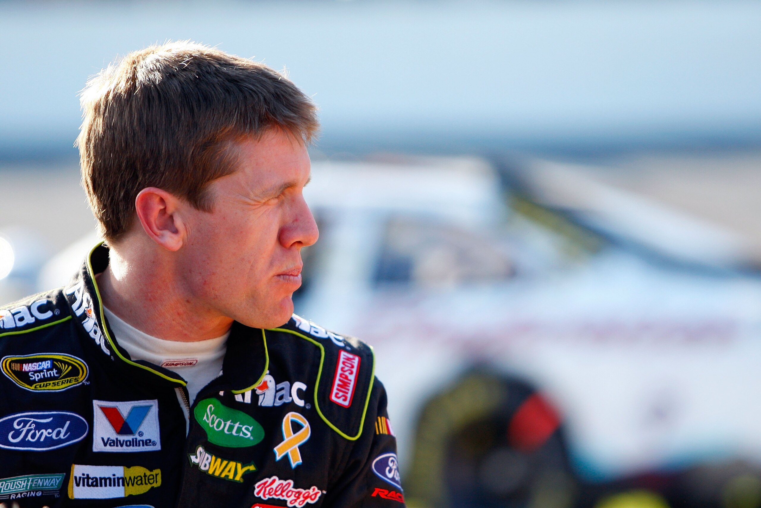 DAYTONA BEACH, FL - FEBRUARY 14:  Carl Edwards, driver of the #99 Aflac Ford, stands on pit road during a red flag stoppage due to track damage during the NASCAR Sprint Cup Series Daytona 500 at Daytona International Speedway on February 14, 2010 in Dayto