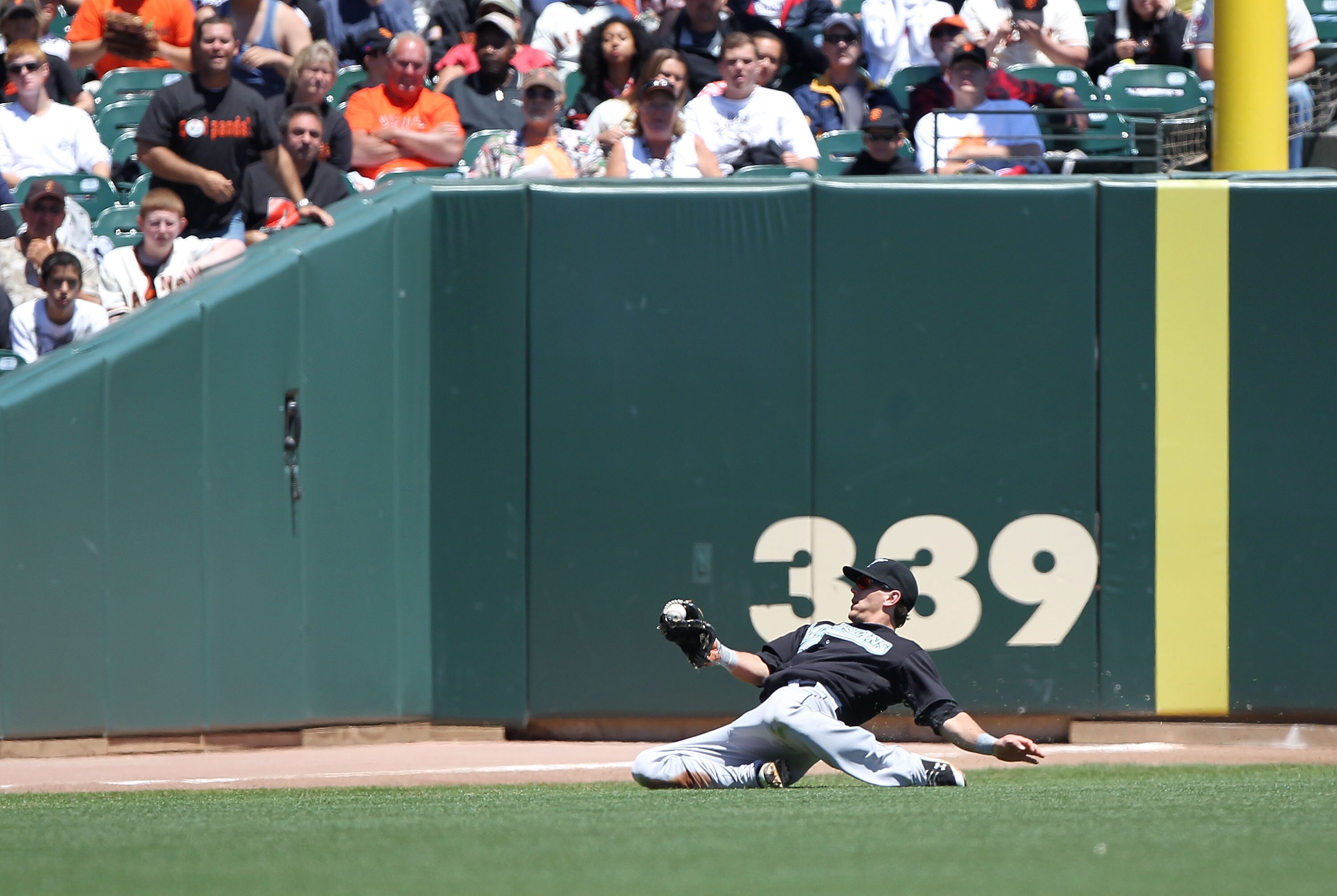 SAN FRANCISCO - JULY 29:  Logan Morrison #20 of the Florida Marlins catches a ball hit by Aubrey Huff #17 of the San Francisco Giants in the first inning during an MLB game at AT&T Park on July 29, 2010 in San Francisco, California. (Photo by Jed Jacobsoh