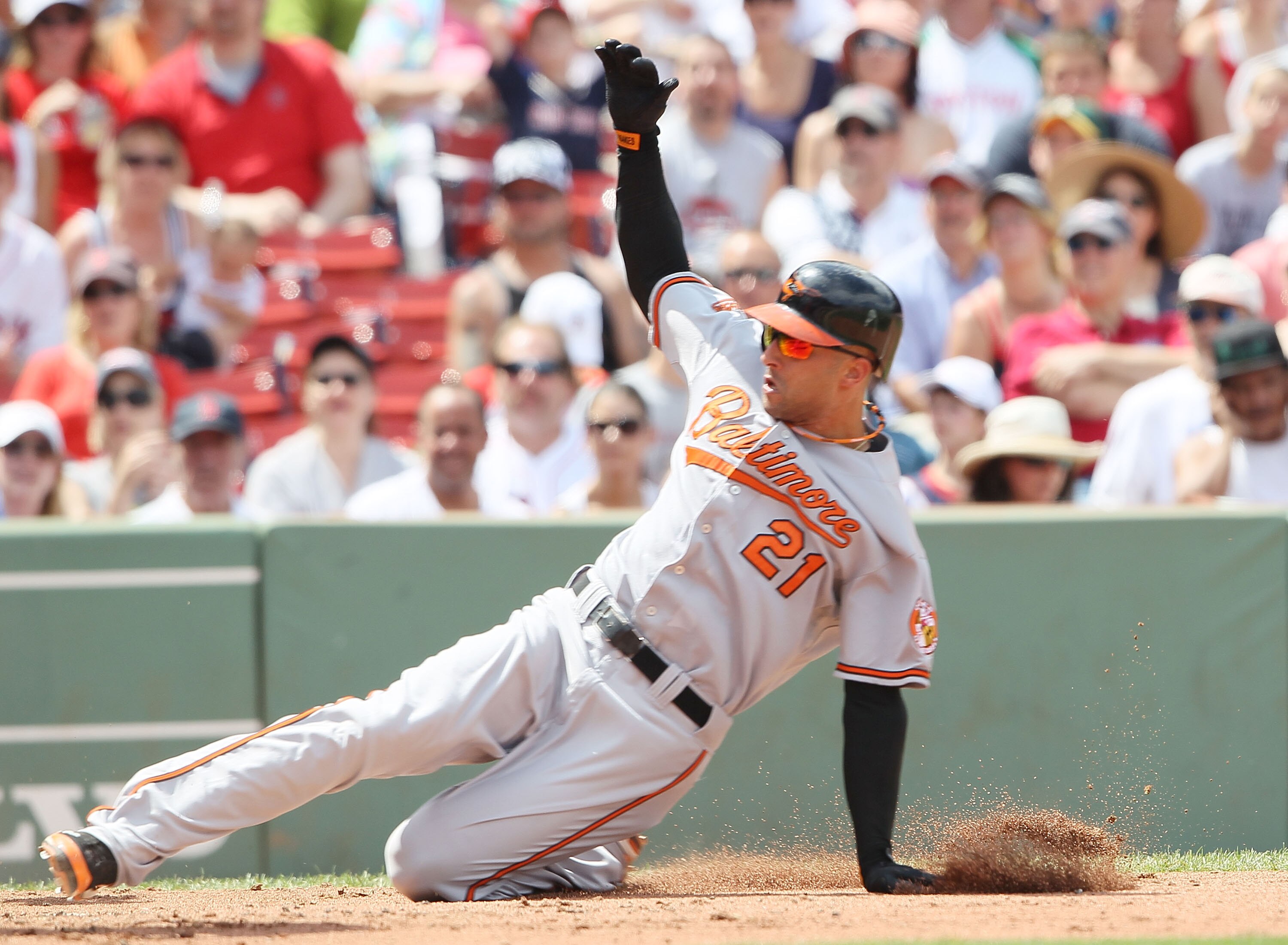 BOSTON - JULY 04:  Nick Markakis #21 of the Baltimore Orioles scores a run on a wild pitch in the fourth inning against the Boston Red Sox on July 4, 2010 at Fenway Park in Boston, Massachusetts.  (Photo by Elsa/Getty Images)