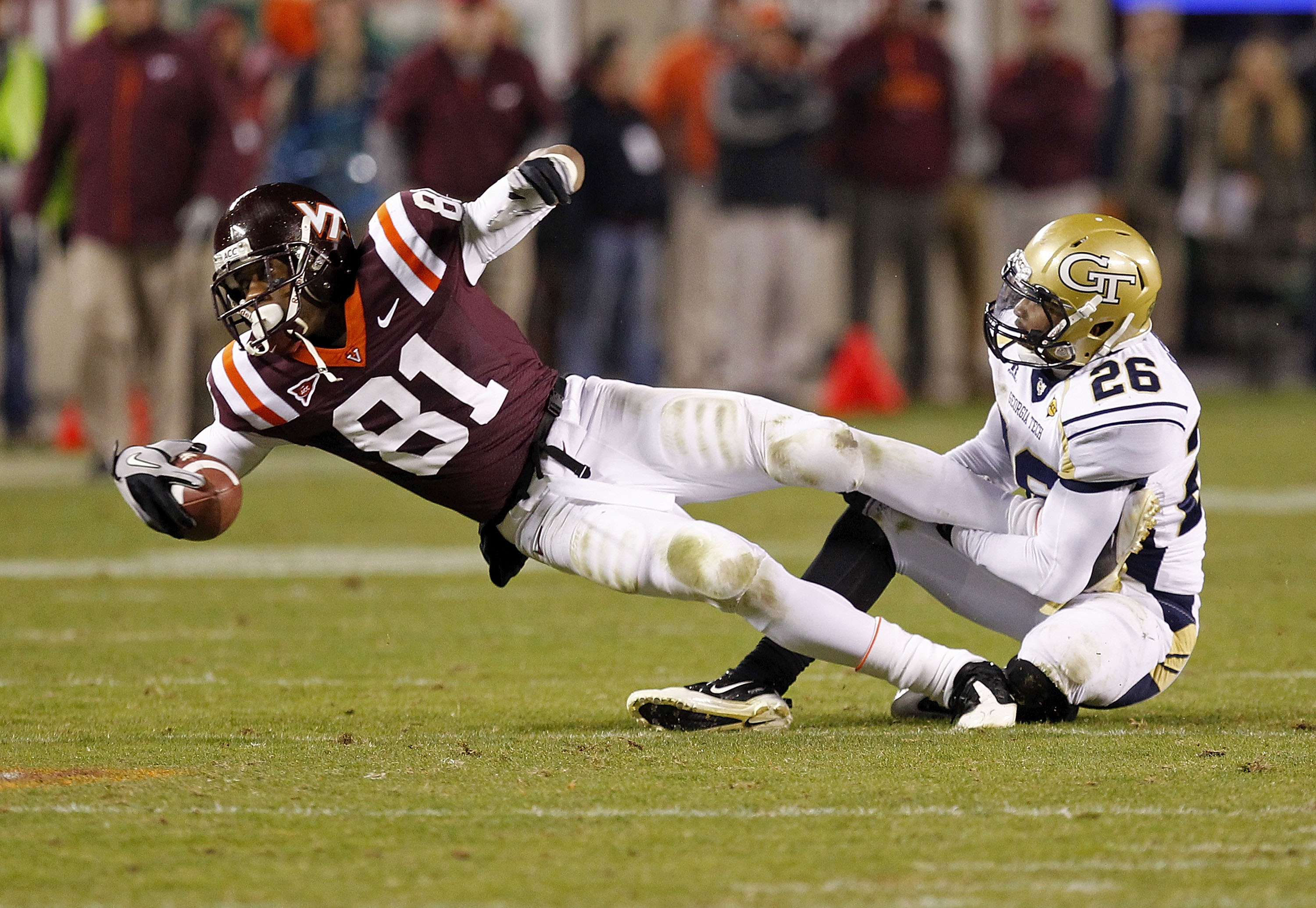 BLACKSBURG, VA - NOVEMBER 04: Wide receiver Jarrett Boykin #81 of the Virginia Tech Hokies dives after catching the ball as cornerback Dominique Reese #26 of the Georgia Tech Yellow Jackets makes the tackle at Lane Stadium on November 4, 2010 in Blacksbur