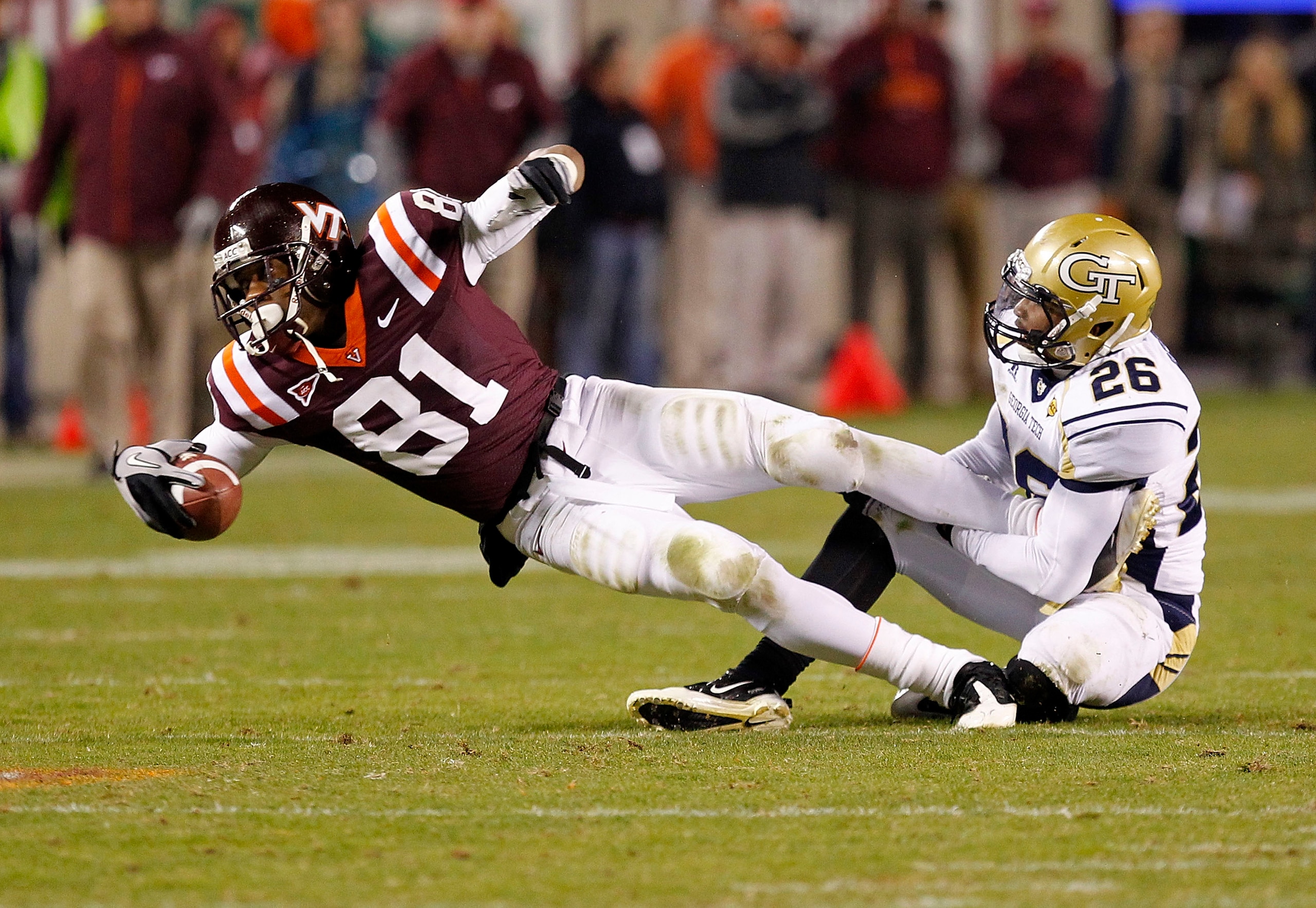BLACKSBURG, VA - NOVEMBER 04: Wide receiver Jarrett Boykin #81 of the Virginia Tech Hokies dives after catching the ball as cornerback Dominique Reese #26 of the Georgia Tech Yellow Jackets makes the tackle at Lane Stadium on November 4, 2010 in Blacksbur