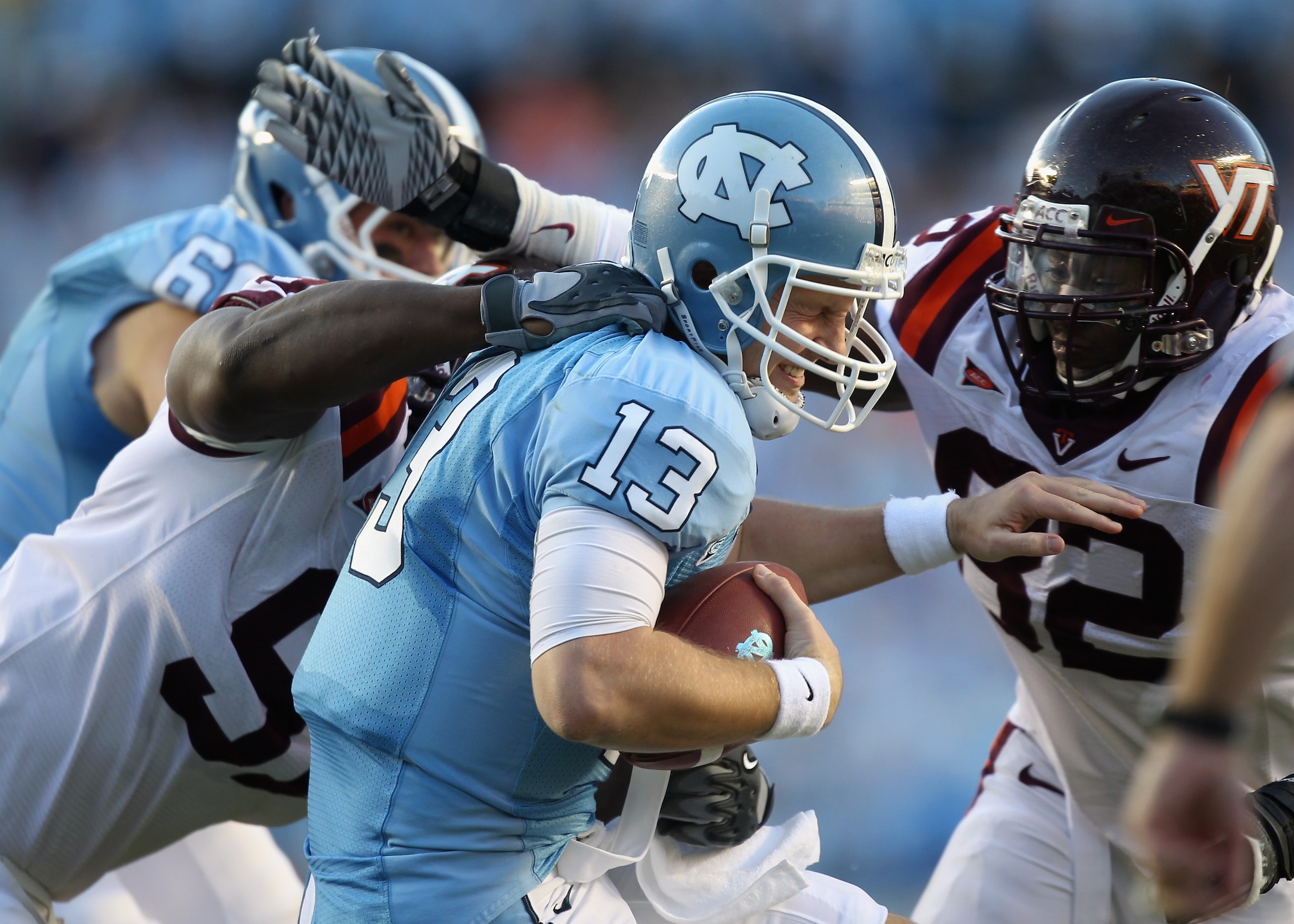 CHAPEL HILL, NC - NOVEMBER 13:  Teammates John Graves #91 and Steven Friday #82 of the Virginia Tech Hokies sack T.J. Yates #13 of the North Carolina Tar Heels during their game at Kenan Stadium on November 13, 2010 in Chapel Hill, North Carolina.  (Photo
