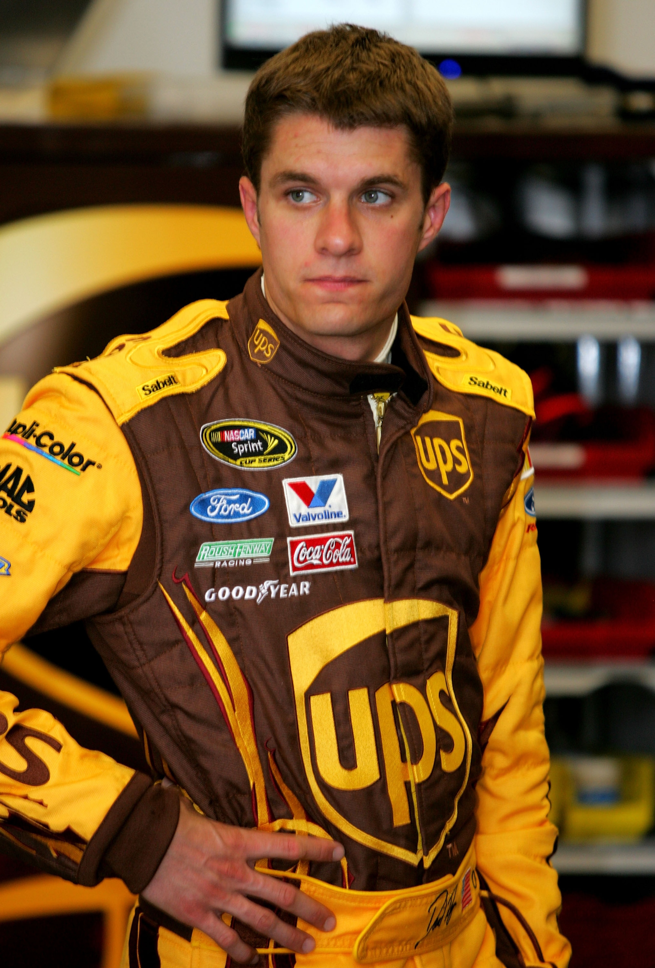 DAYTONA BEACH, FL - FEBRUARY 05:  David Ragan, driver of the #6 UPS Ford, stands in the garage area during practice for the NASCAR Sprint Cup Series Daytona 500 at Daytona International Speedway on February 5, 2010 in Daytona Beach, Florida.  (Photo by Je