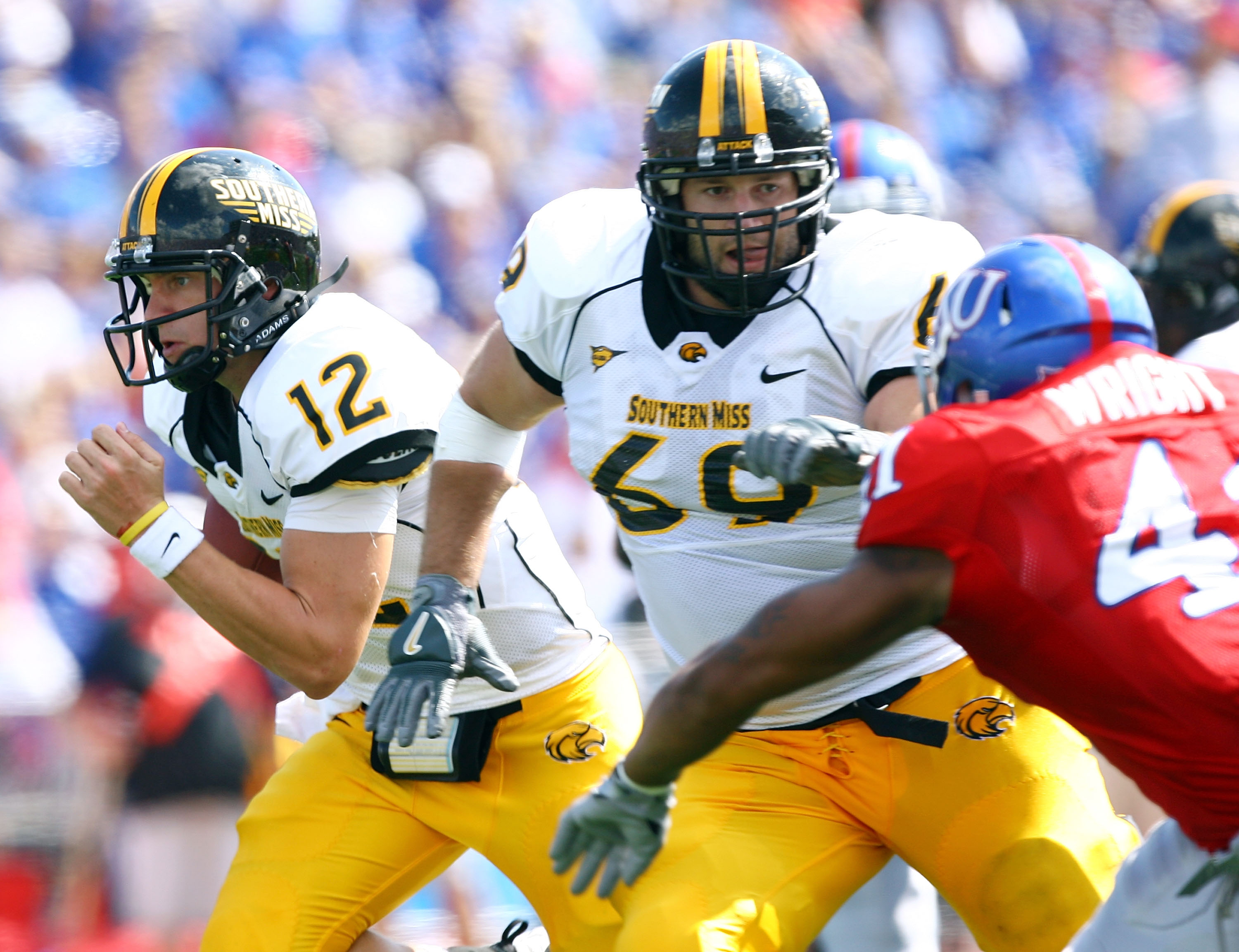 LAWRENCE, KS - SEPTEMBER 26: Quarterback Austin Davis #12 of the Southern Mississippi Golden Eagles scrambles as Micah Brown #69 throws a block during the game against the Kansas Jayhawks on September 26, 2009 at Memorial Stadium in Lawrence, Kansas. (P LAWRENCE, KS - SEPTEMBER 26: Quarterback Austin Davis #12 of the Southern Mississippi Golden Eagles scrambles as Micah Brown #69 throws a block during the game against the Kansas Jayhawks on September 26, 2009 at Memorial Stadium in Lawrence, Kansas. (P