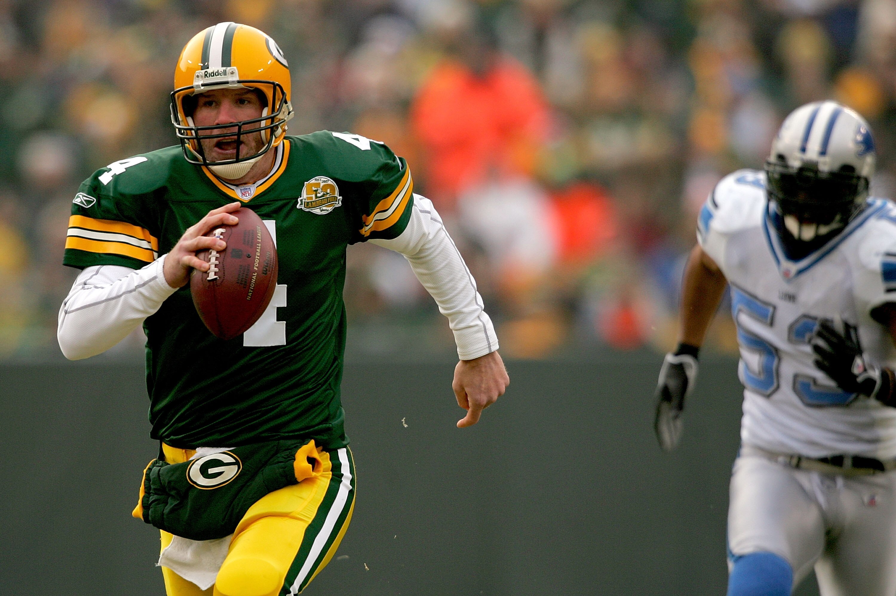 GREEN BAY, WI - DECEMBER 30: Quarterback Brett Favre #4 of the Green Bay Packers is chased out of the pocket by Paris Lenon #53 of the Detroit Lions December 30, 2007 at Lambeau Field in Green Bay, Wisconsin.  (Photo by Matthew Stockman/Getty Images)