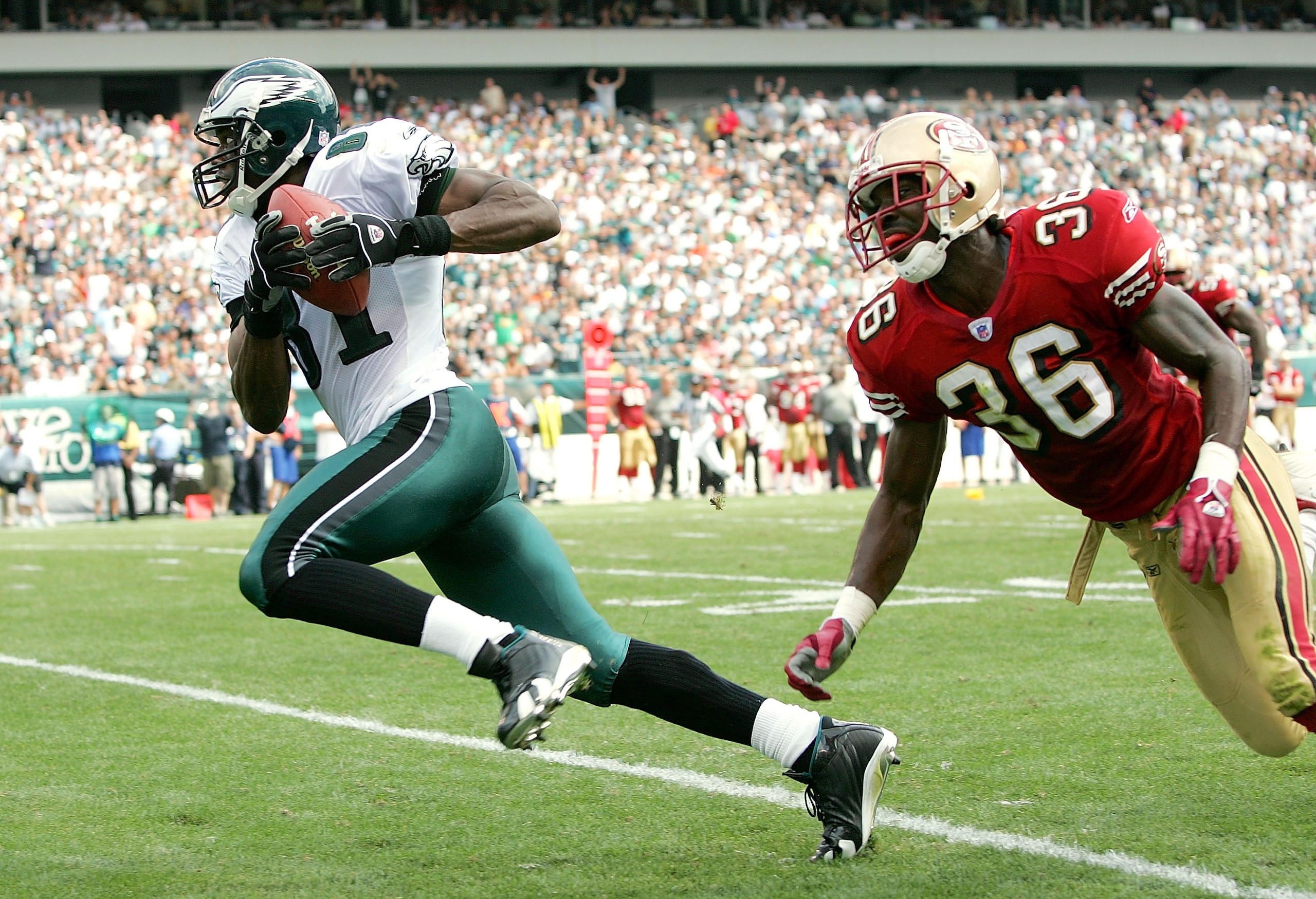 PHILADELPHIA - SEPTEMBER 18:  Terrell Owens #81 of the Philadelphia Eagles catches a pass for a touchdown as Shawntae Spencer #36 of the San Francisco 49ers defends during the first half of the game on September 18, 2005 at Lincoln Financial Field in Phil