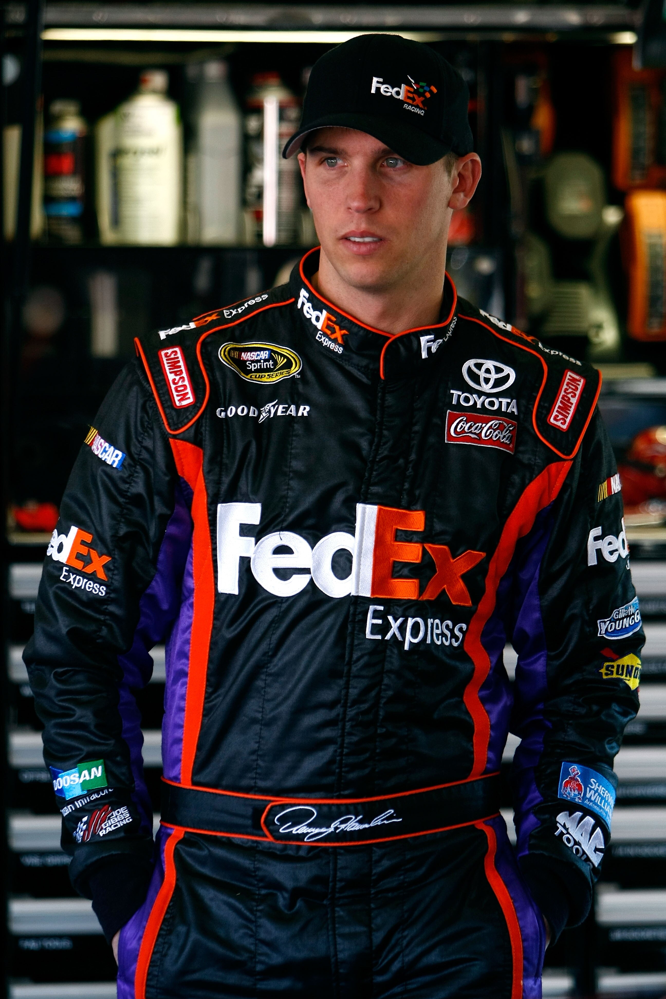 DAYTONA BEACH, FL - FEBRUARY 10:  Denny Hamlin, driver of the #11 FedEx Express Toyota, looks on in the garage during practice for the NASCAR Sprint Cup Series Daytona 500 at Daytona International Speedway on February 10, 2010 in Daytona Beach, Florida.