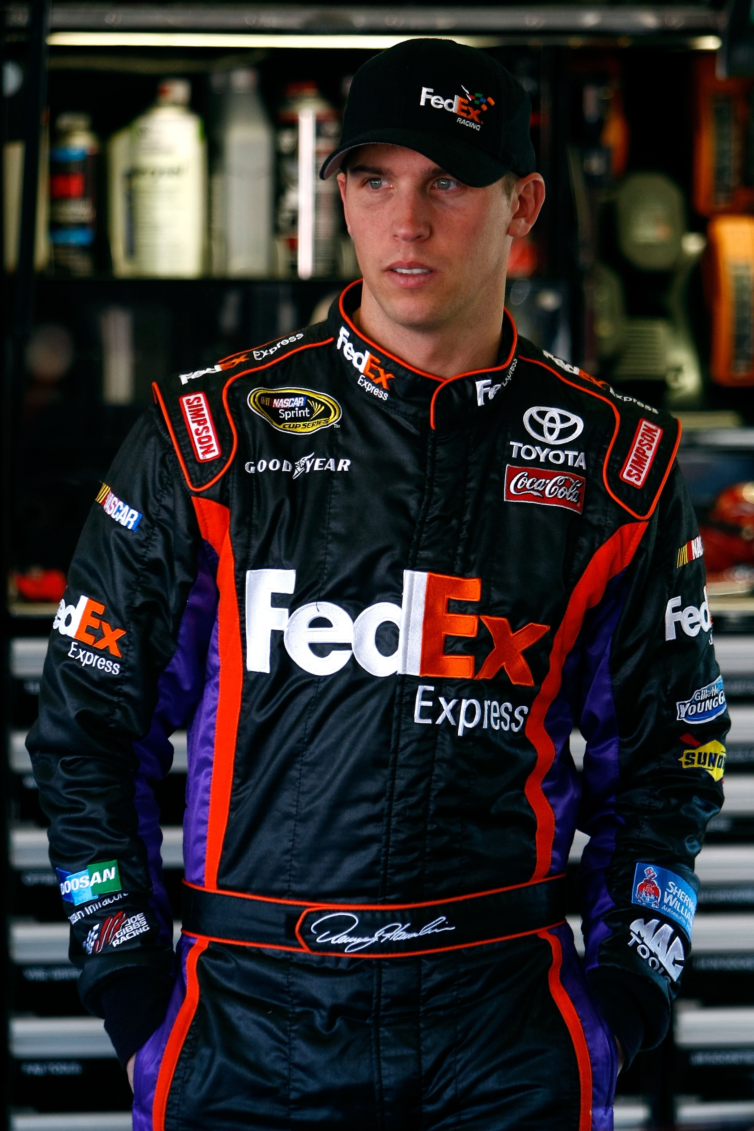 DAYTONA BEACH, FL - FEBRUARY 10:  Denny Hamlin, driver of the #11 FedEx Express Toyota, looks on in the garage during practice for the NASCAR Sprint Cup Series Daytona 500 at Daytona International Speedway on February 10, 2010 in Daytona Beach, Florida.