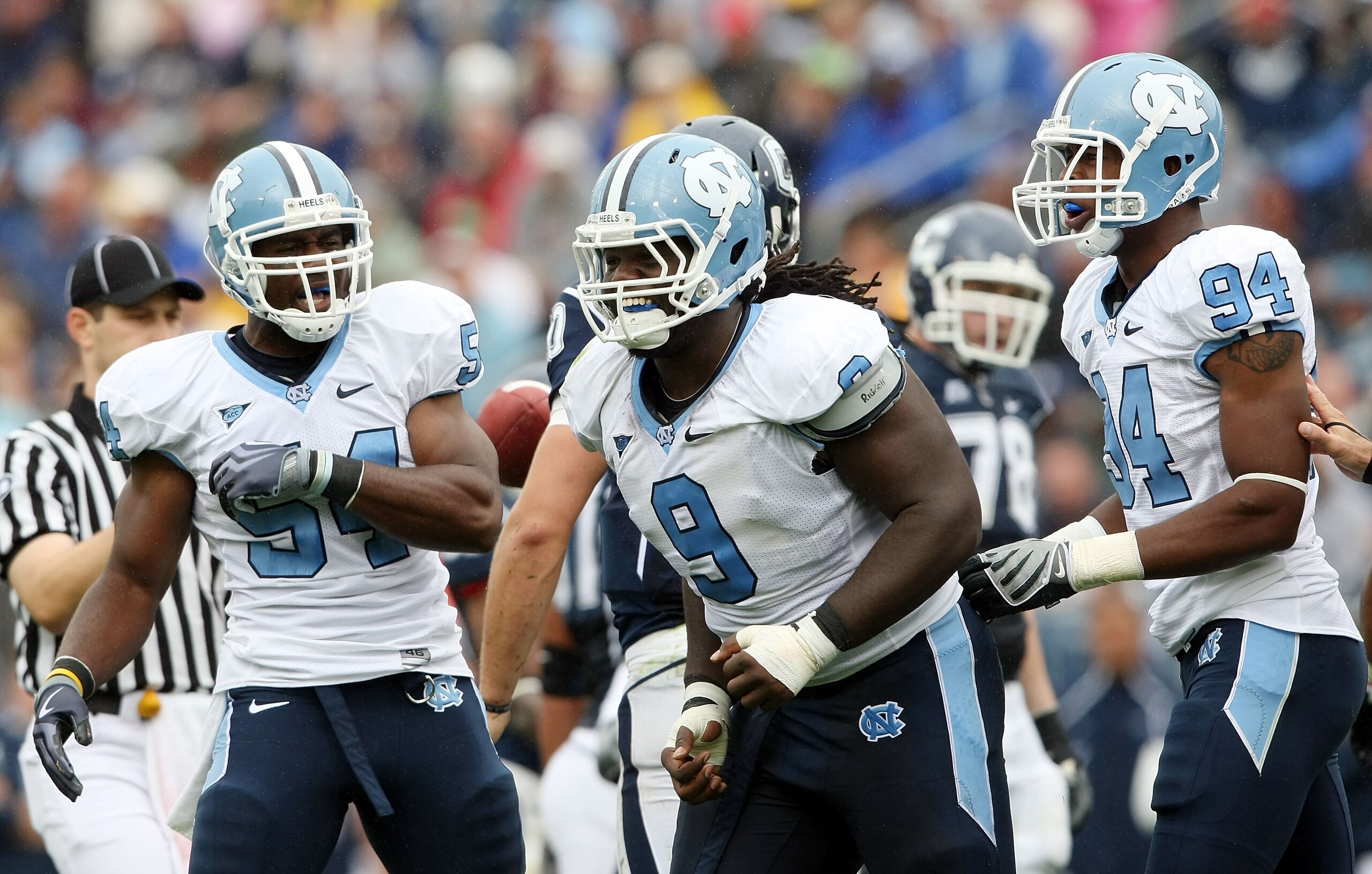 EAST HARTFORD, CT - SEPTEMBER 12:  Bruce Carter #54, Marvin Austin #9 and Michael McAdoo #94 of the North Carolinia Tar Heels celebrate a safety that was awarded to the Tar Heels after the Connecticut Huskies were called for holding on September 12, 2009 